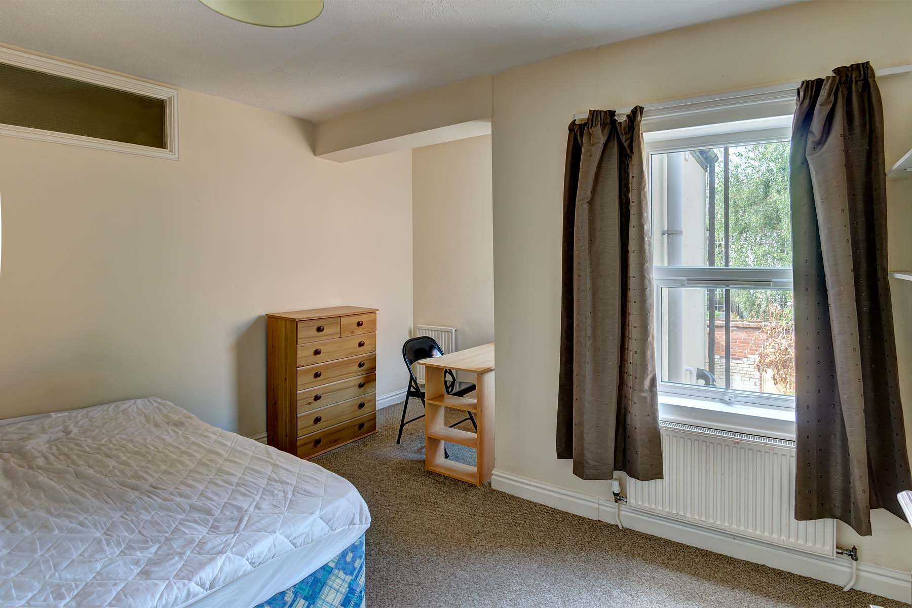 Bedroom with double bed and wooden furnishings