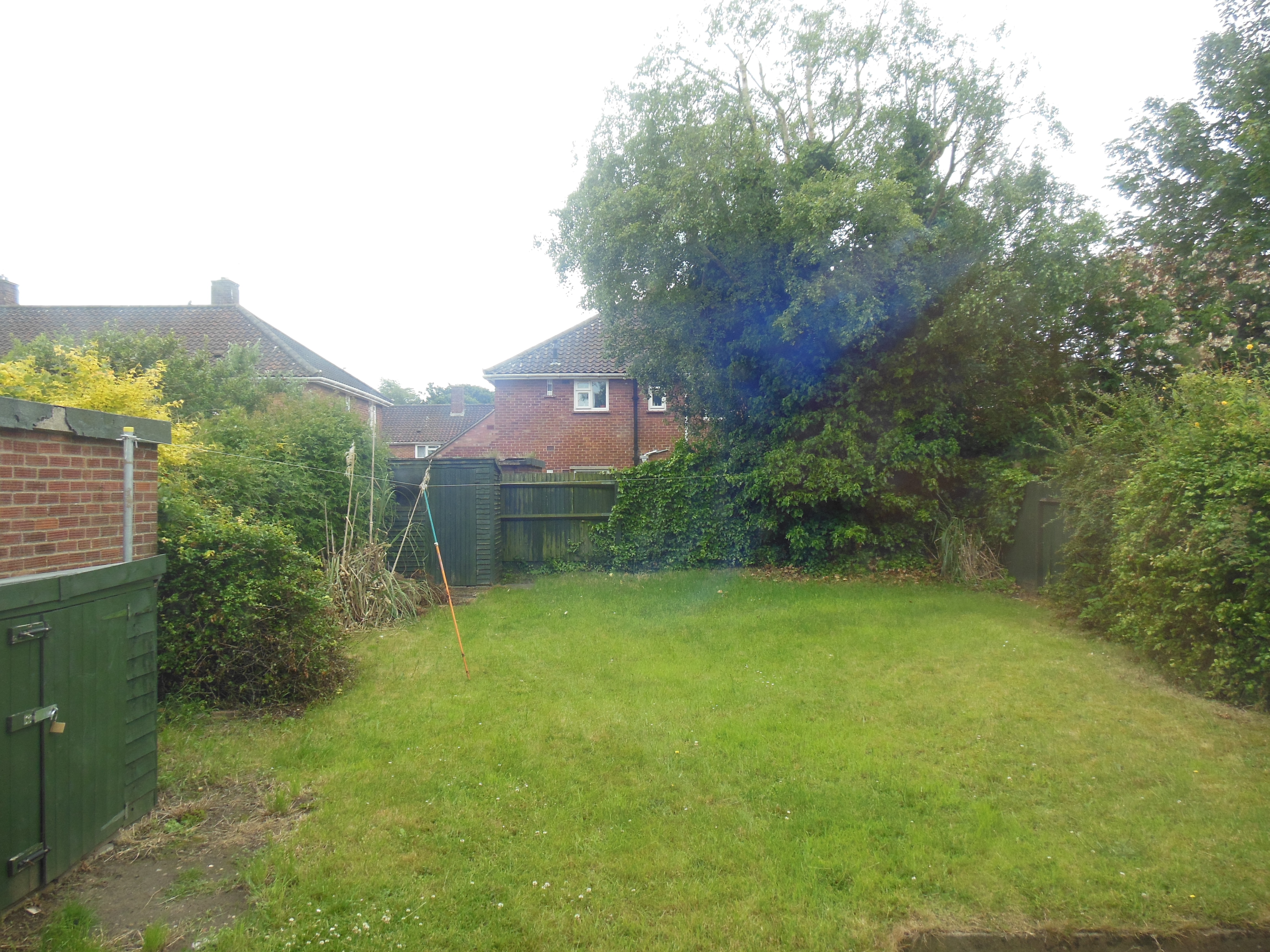 Large rear garden with grass.