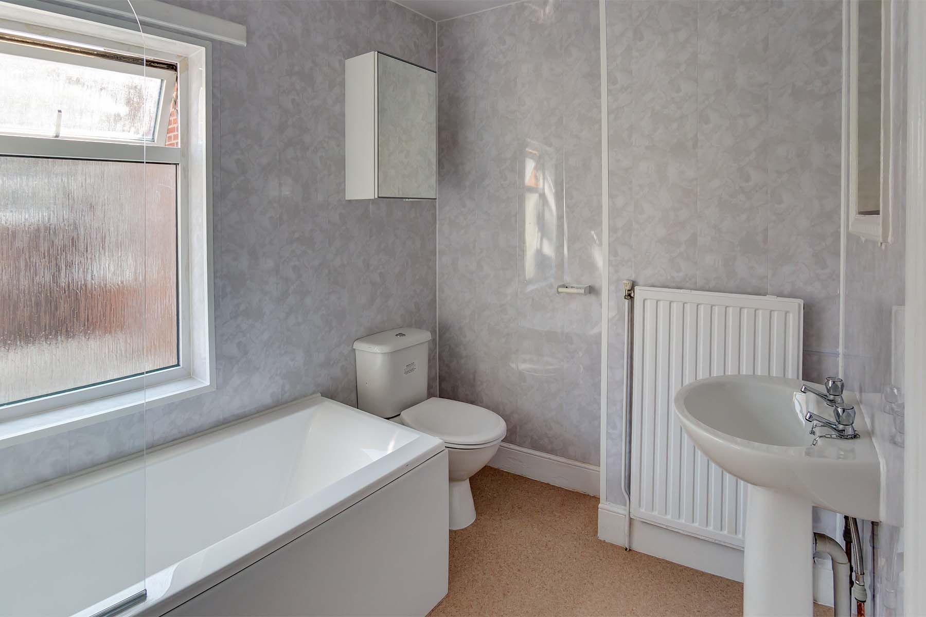 Bathroom with toilet, sink, and bath