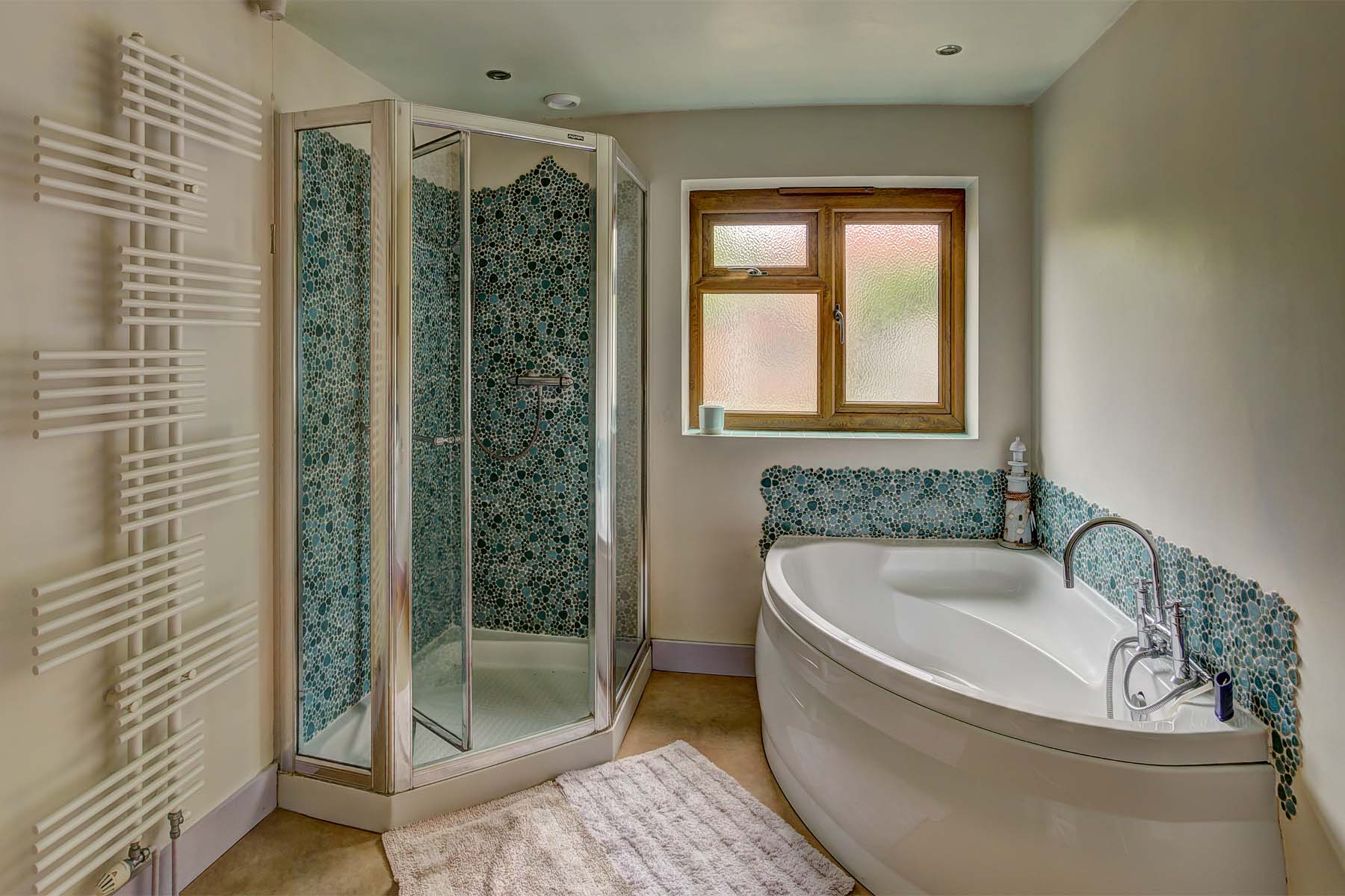 Bathroom with shower cubicle and corner bath tub