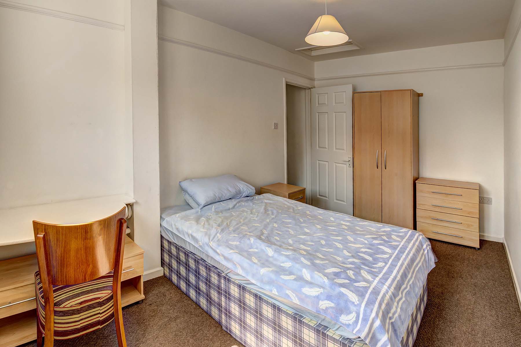 Bedroom with desk and wardrobe