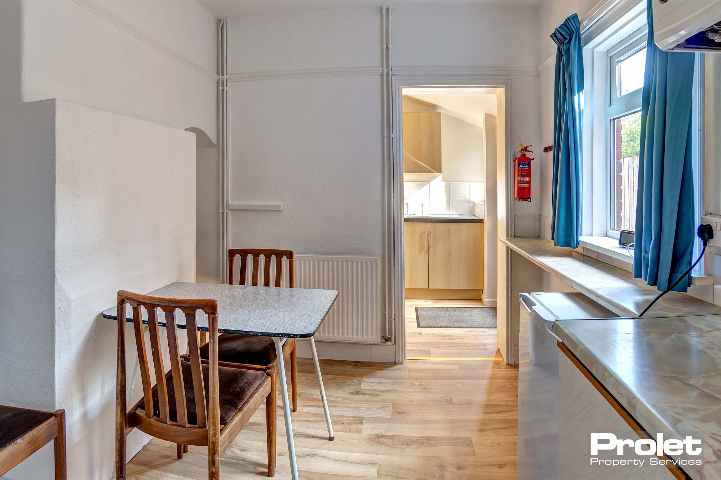 Dining area with a small dining table and 2 chairs.