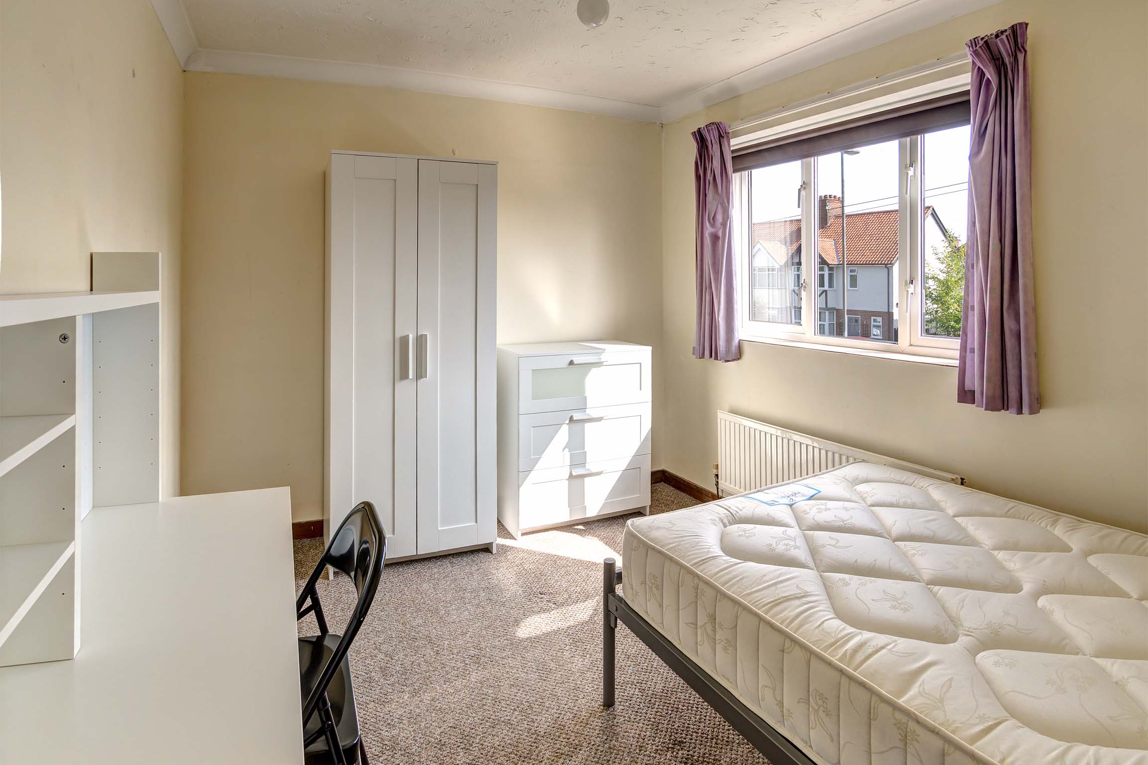 Bedroom with double bed and white furnishings