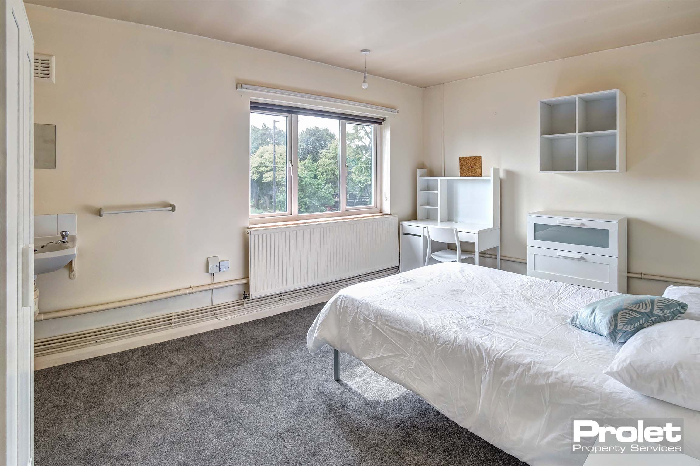 Bedroom with double bed and white furnishings