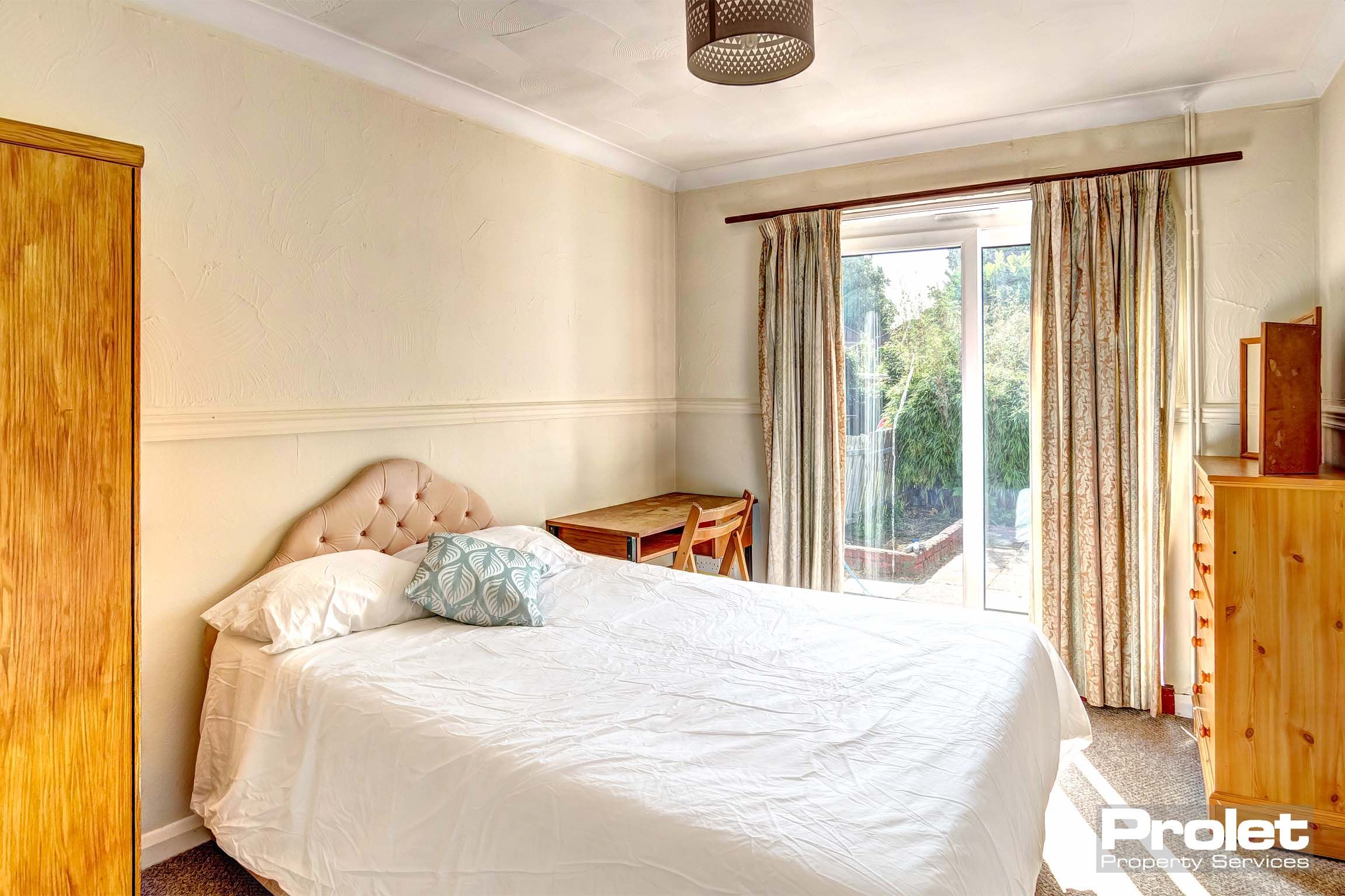 Double bedroom with french doors leading to garden