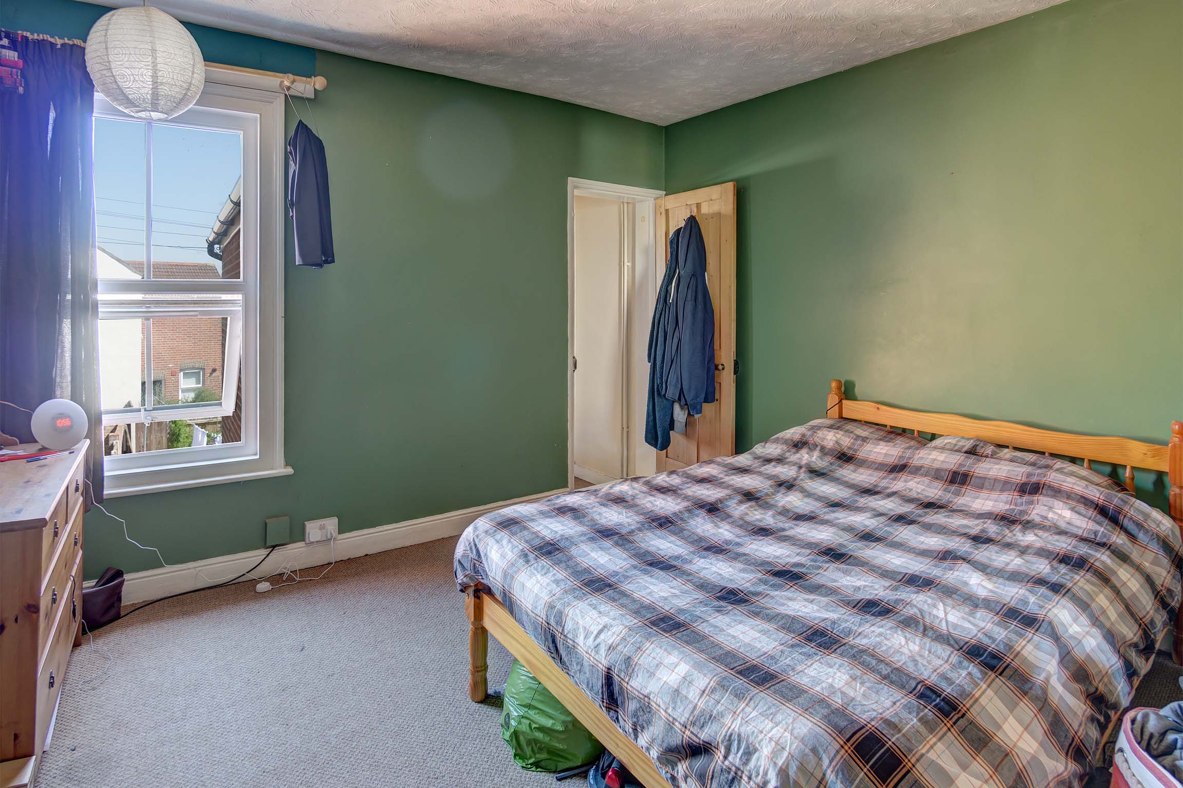 Bedroom with double bed with green walls