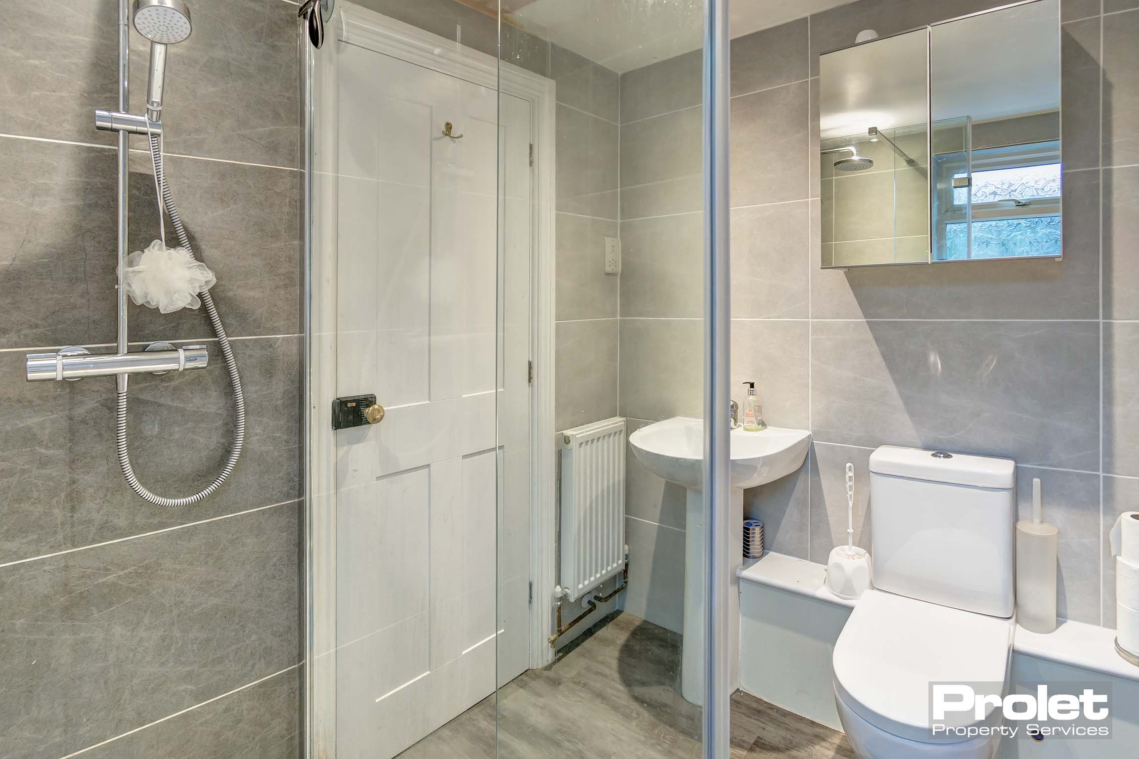 Modern bathroom with shower cubicle, toilet, and sink