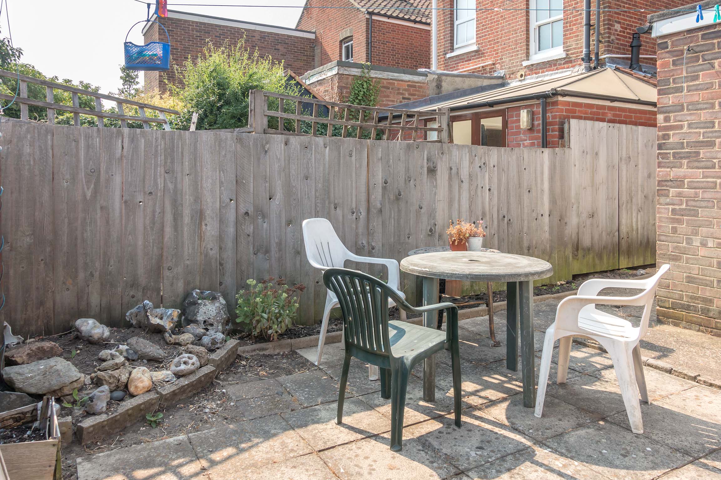 Paved garden with plastic garden furniture