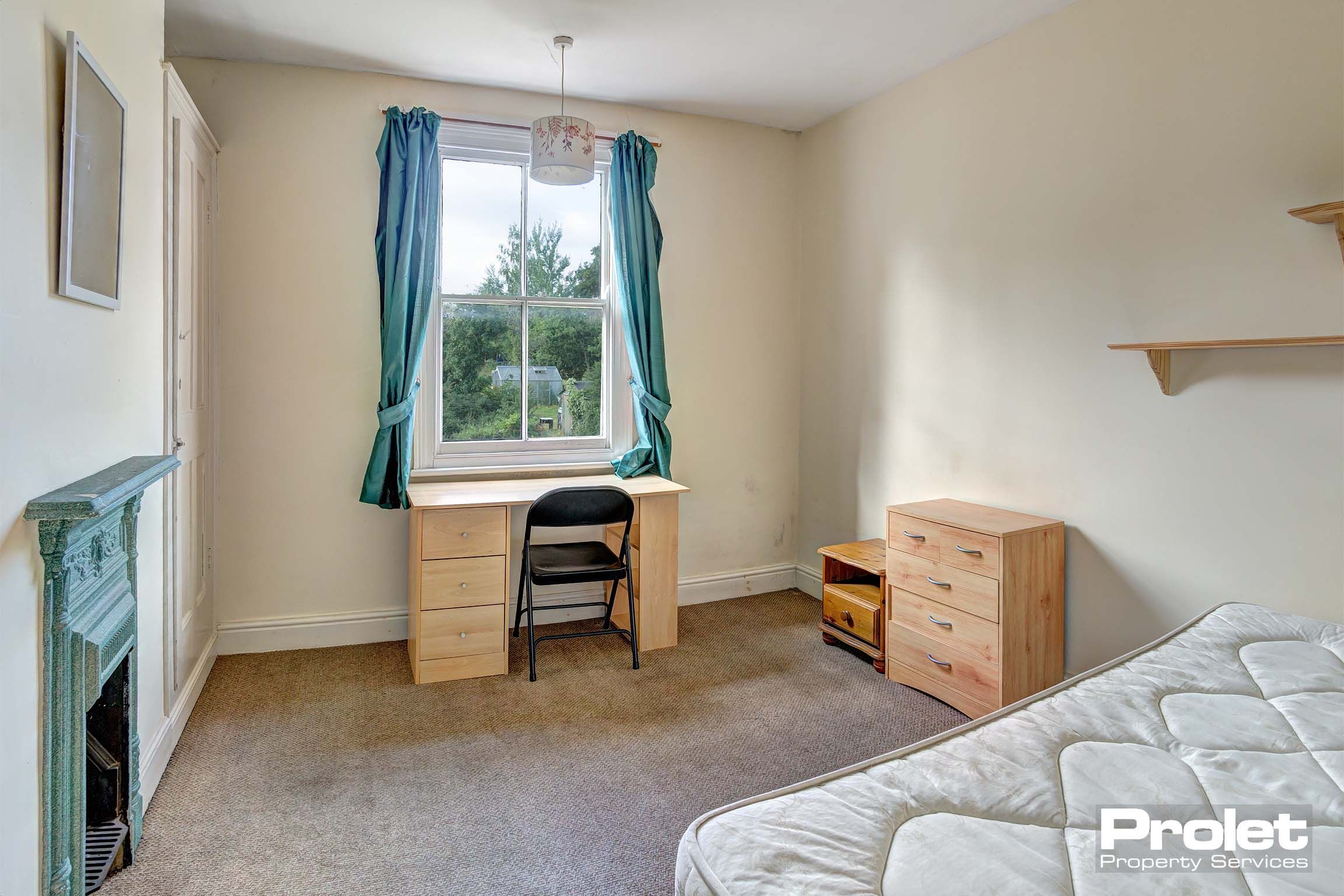 Bedroom with double bed and wooden furnishings