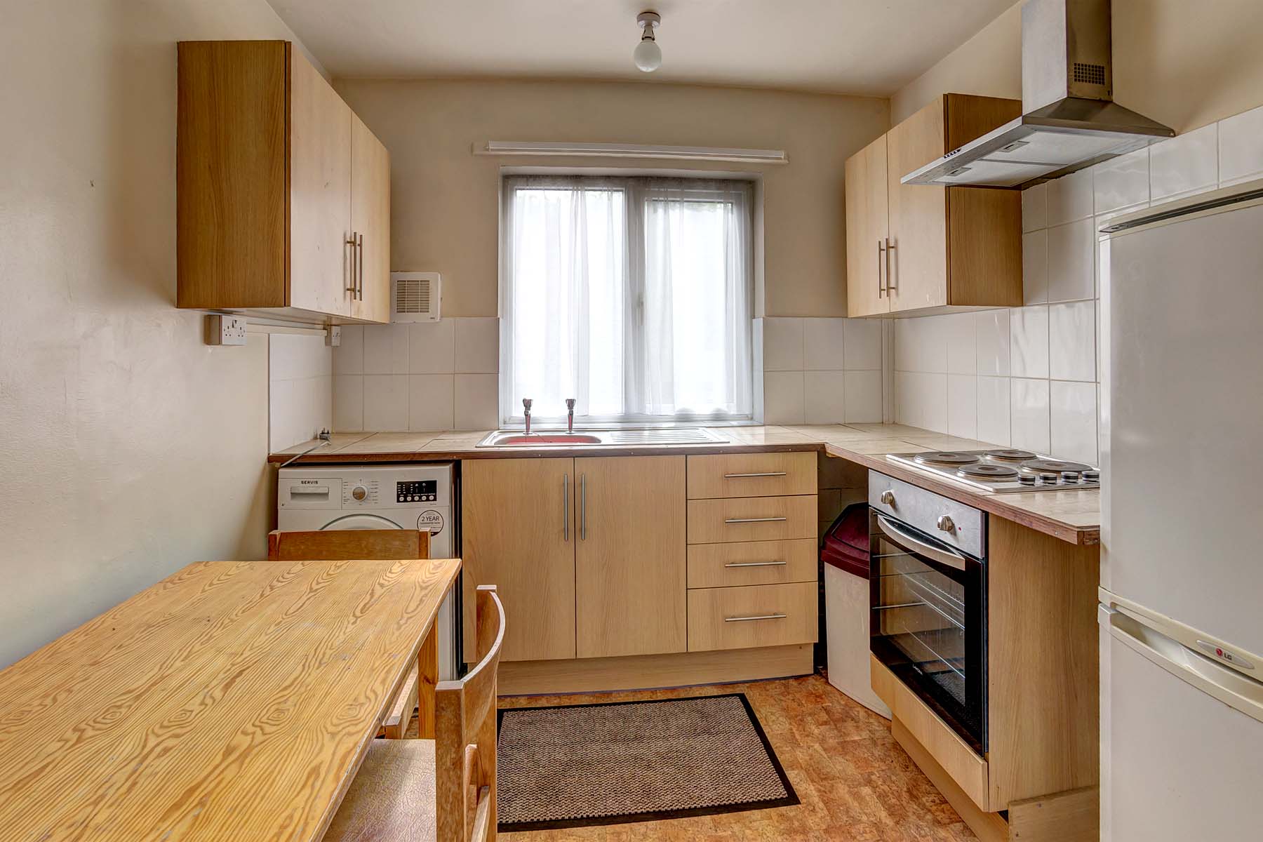 Kitchen with wood effect fittings and white goods