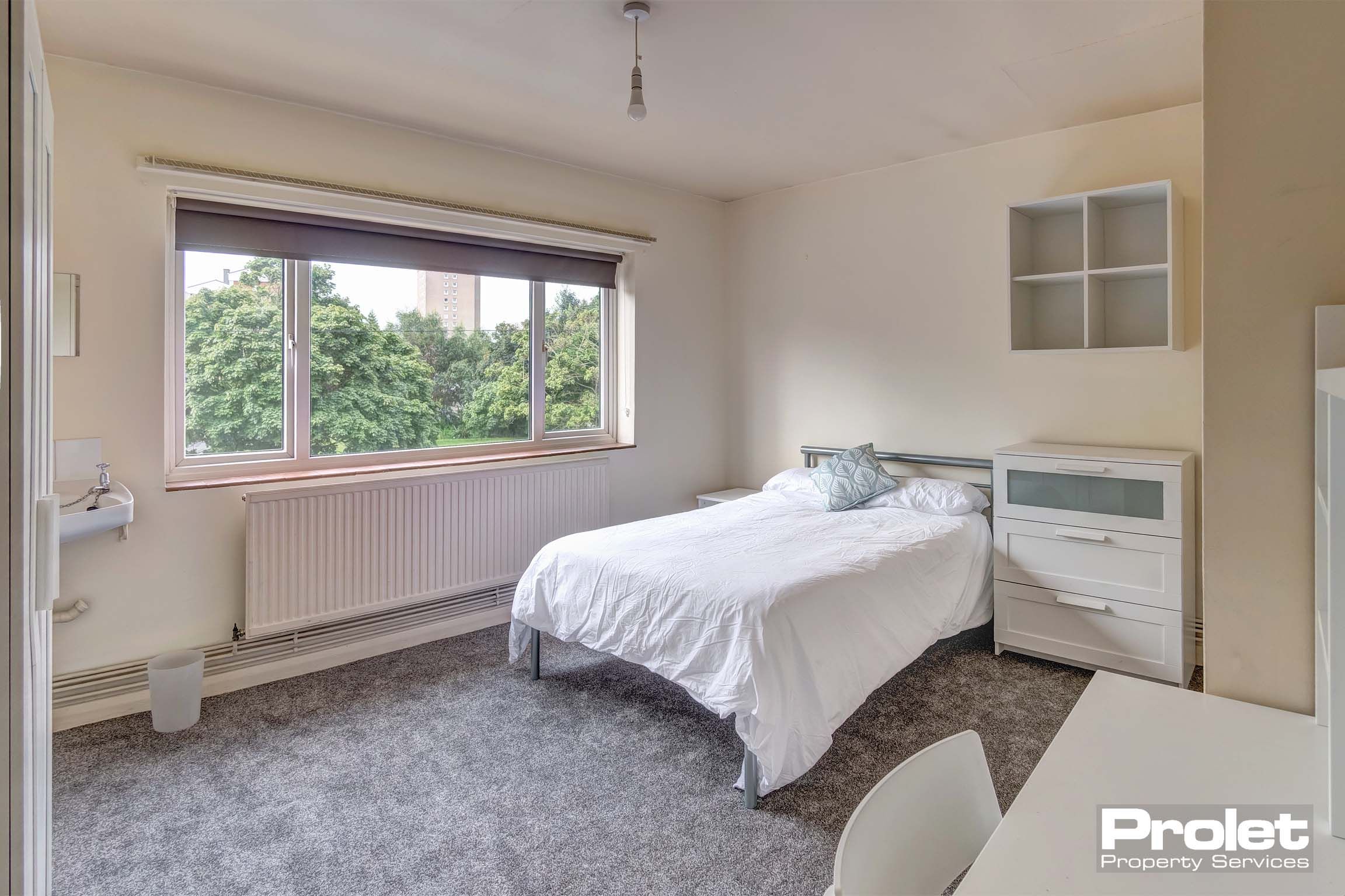 Bedroom with double bed and white furnishings