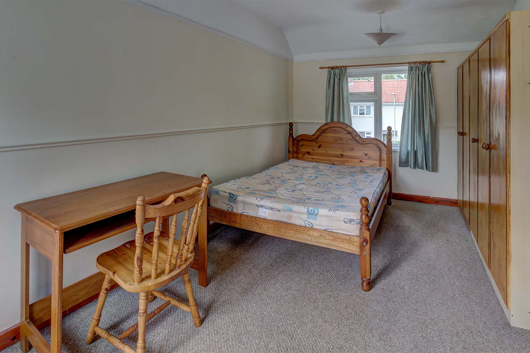 Bedroom with double bed and wooden furnishings