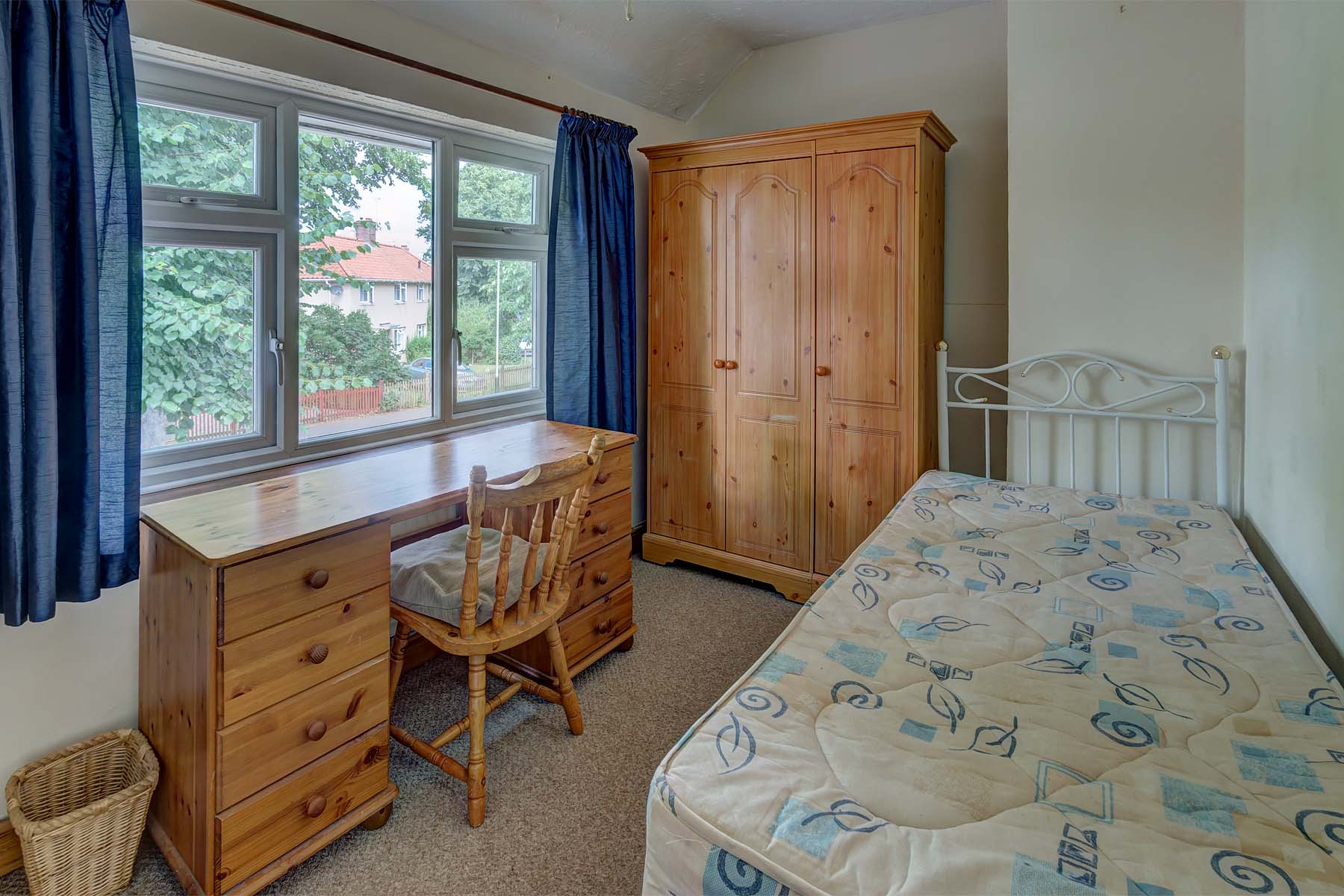 Bedroom with double bed and wooden furnishings