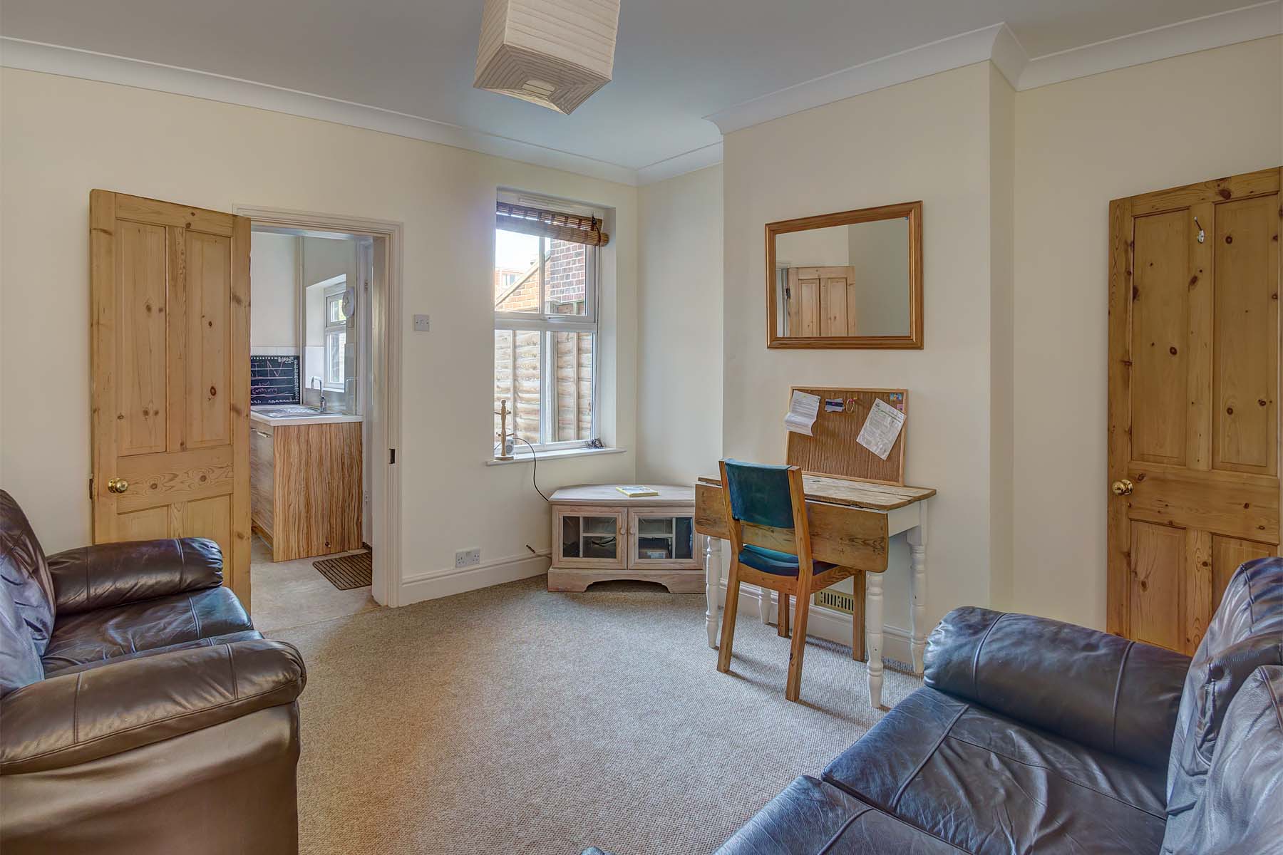 Living room with fold out dining table and sofas