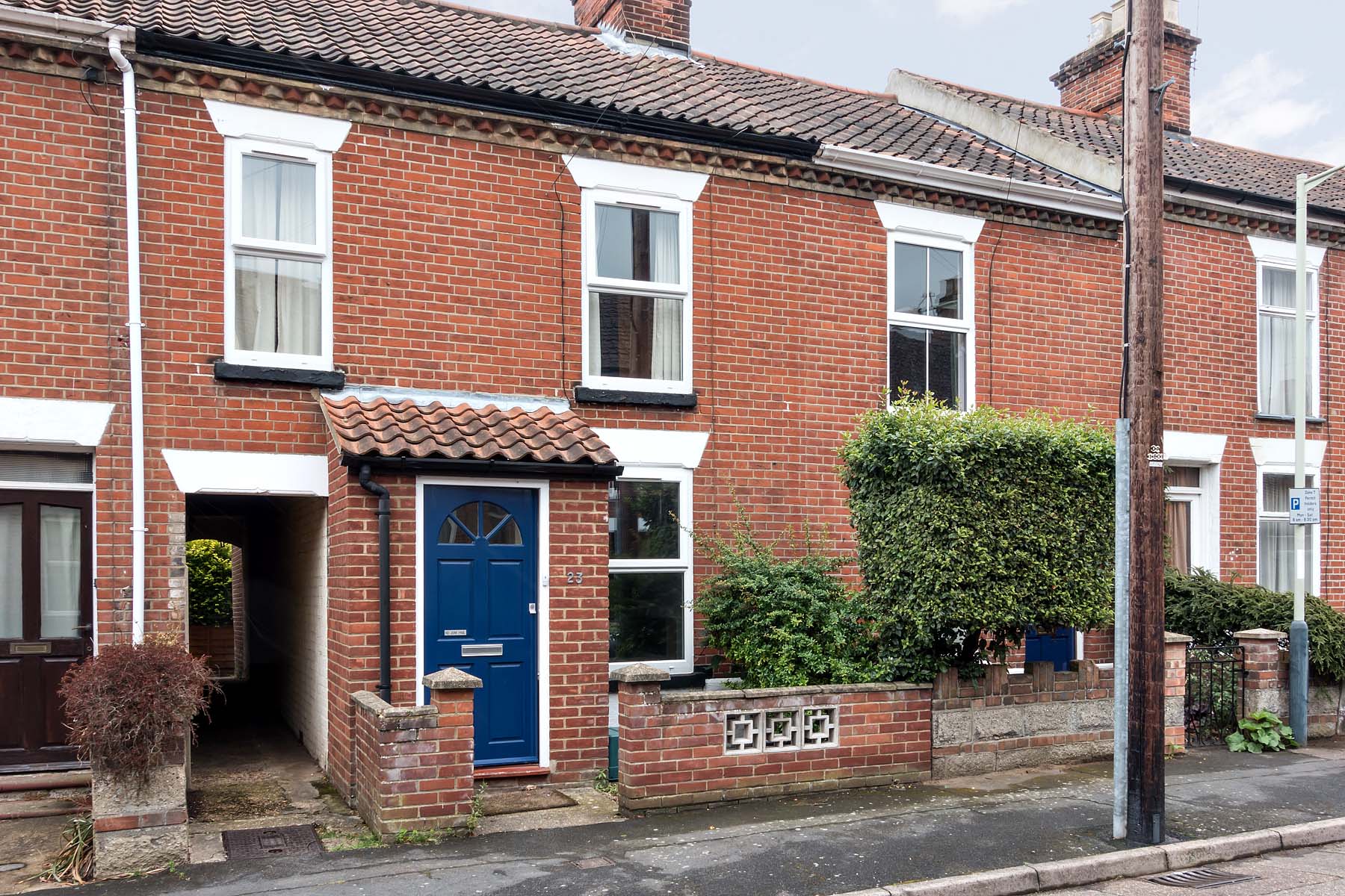 Red brick terraced house with side access and front porch