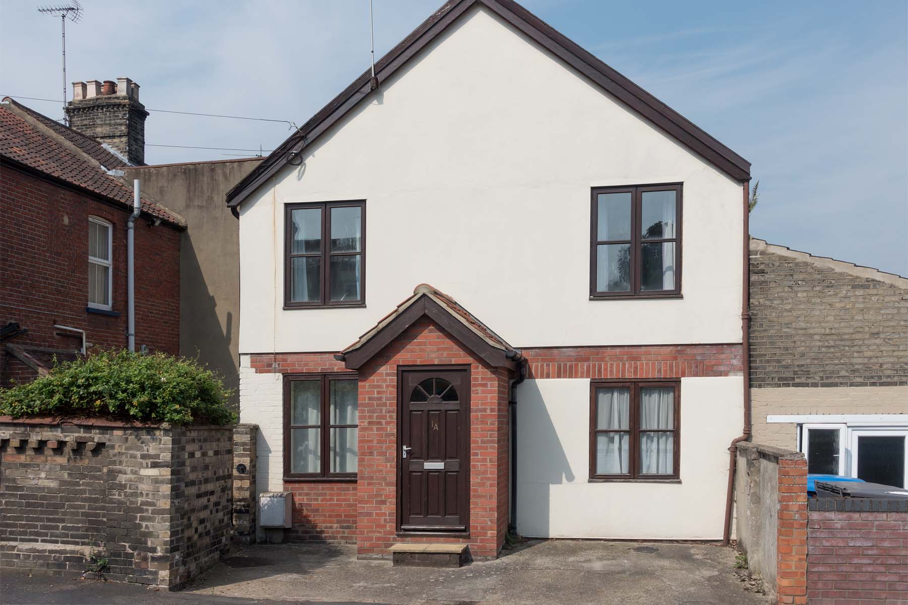 Detached house with brick porch and small driveway