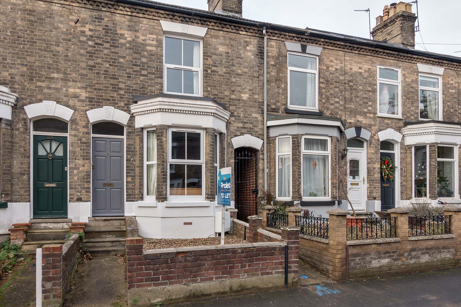 Terraced house with bay window and grey front door