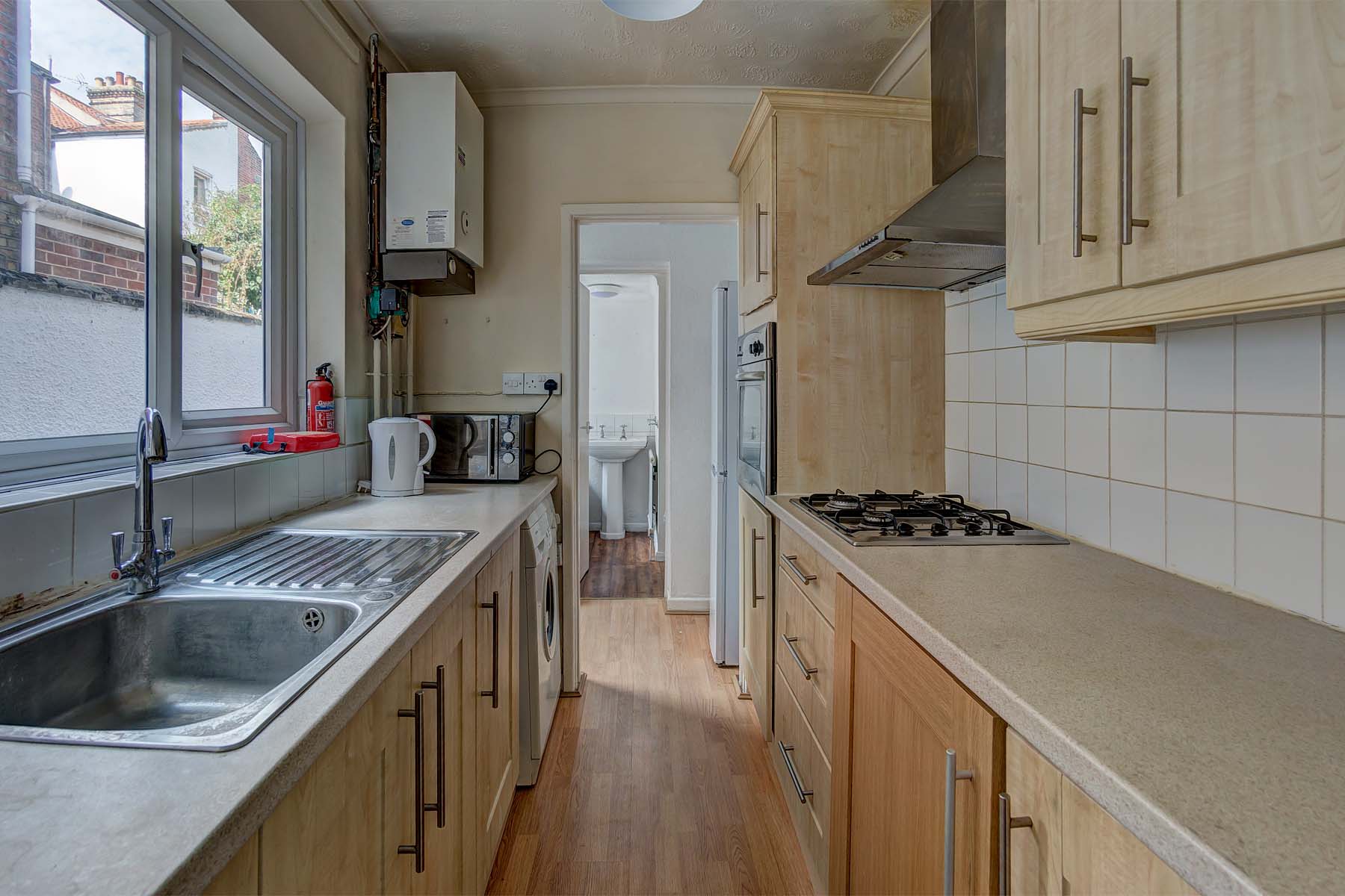 Galley kitchen with wooden units.