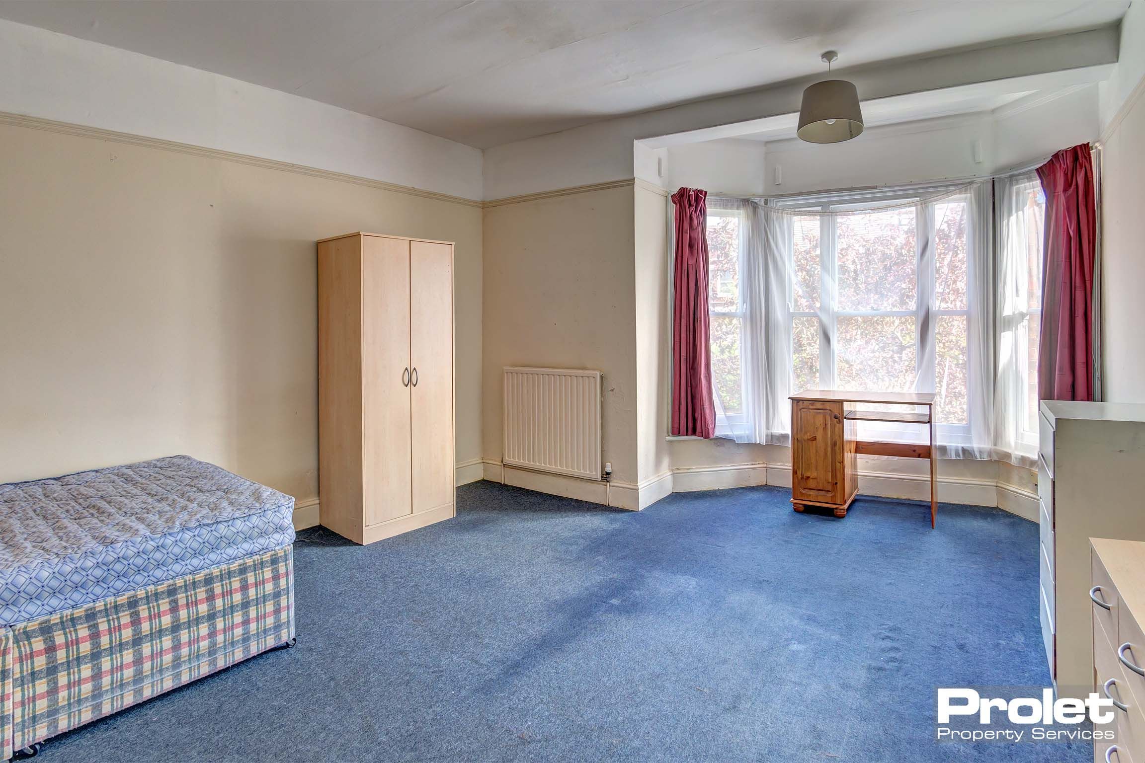 Bedroom with double bed and wooden furnishings