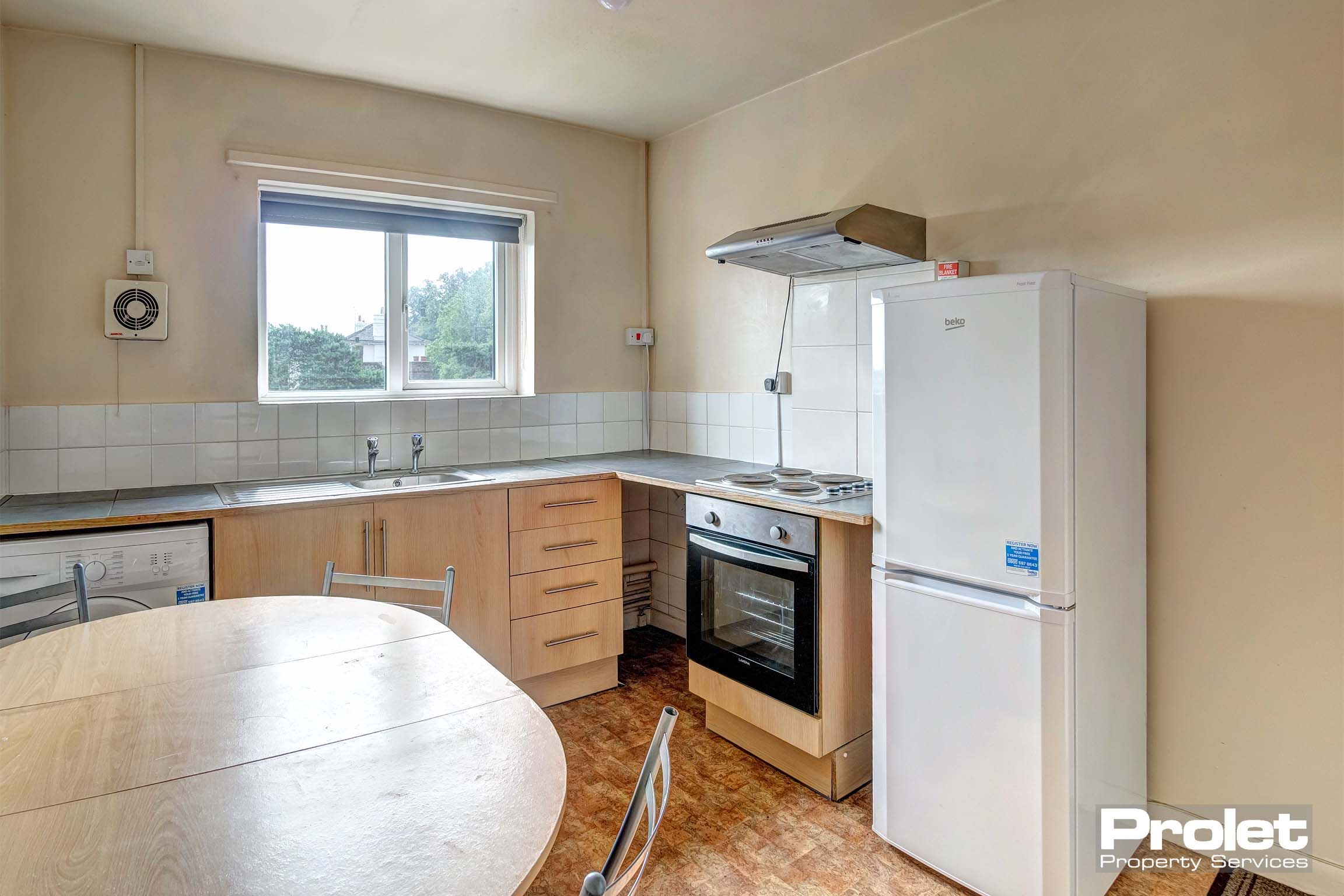 Kitchen with dining table set and white goods