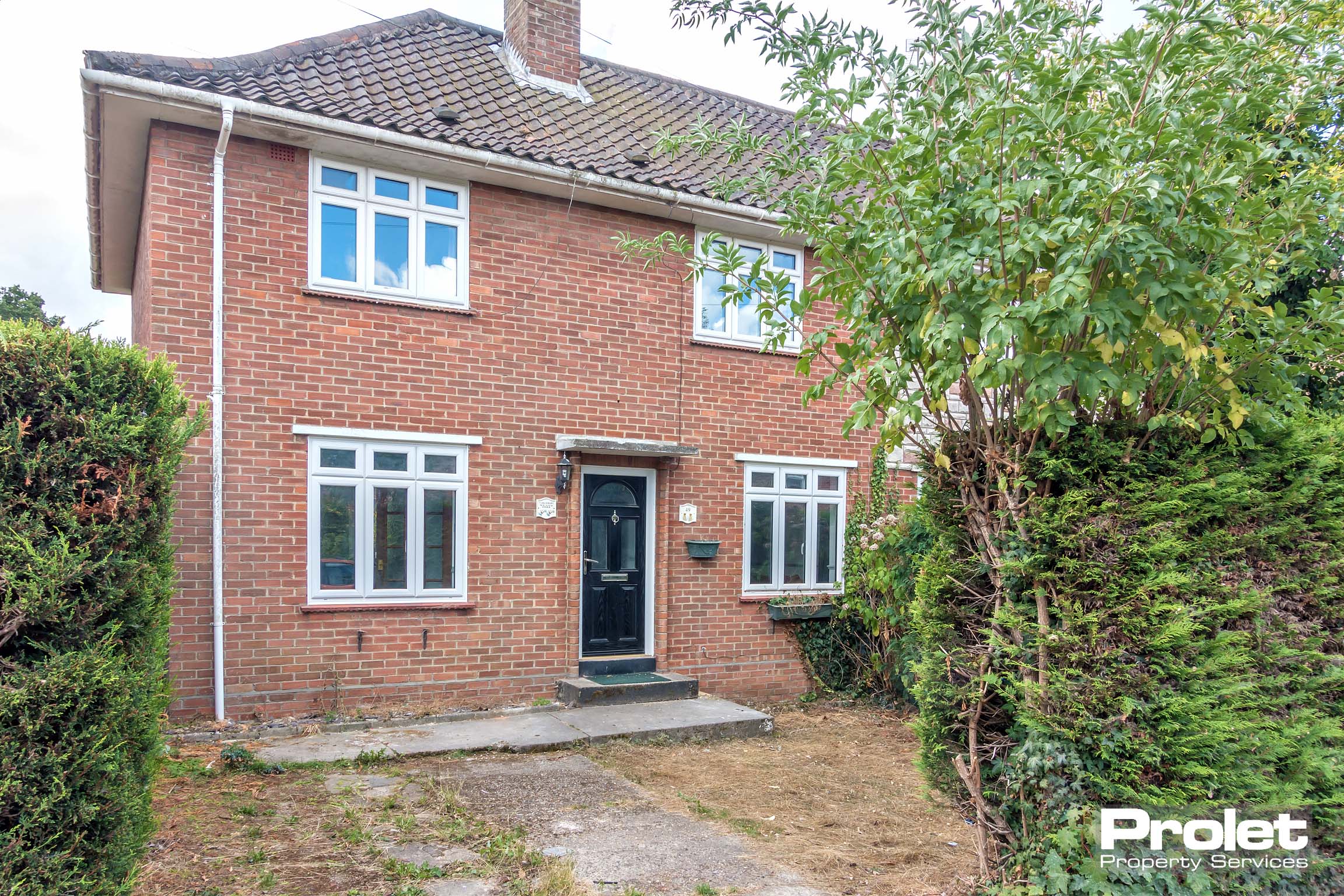 Red brick, semi detached house.