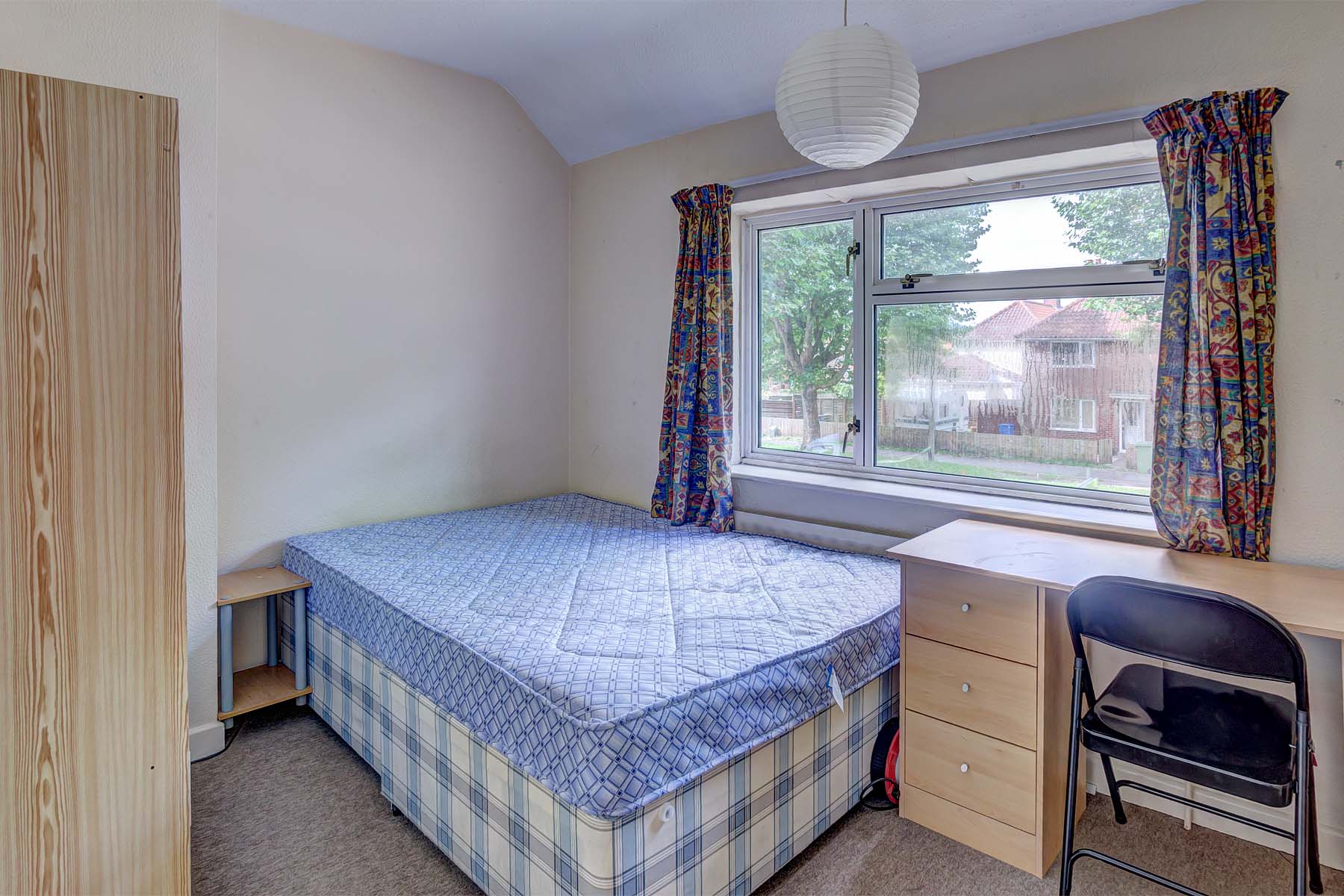 Bedroom with double bed and wooden furnishings