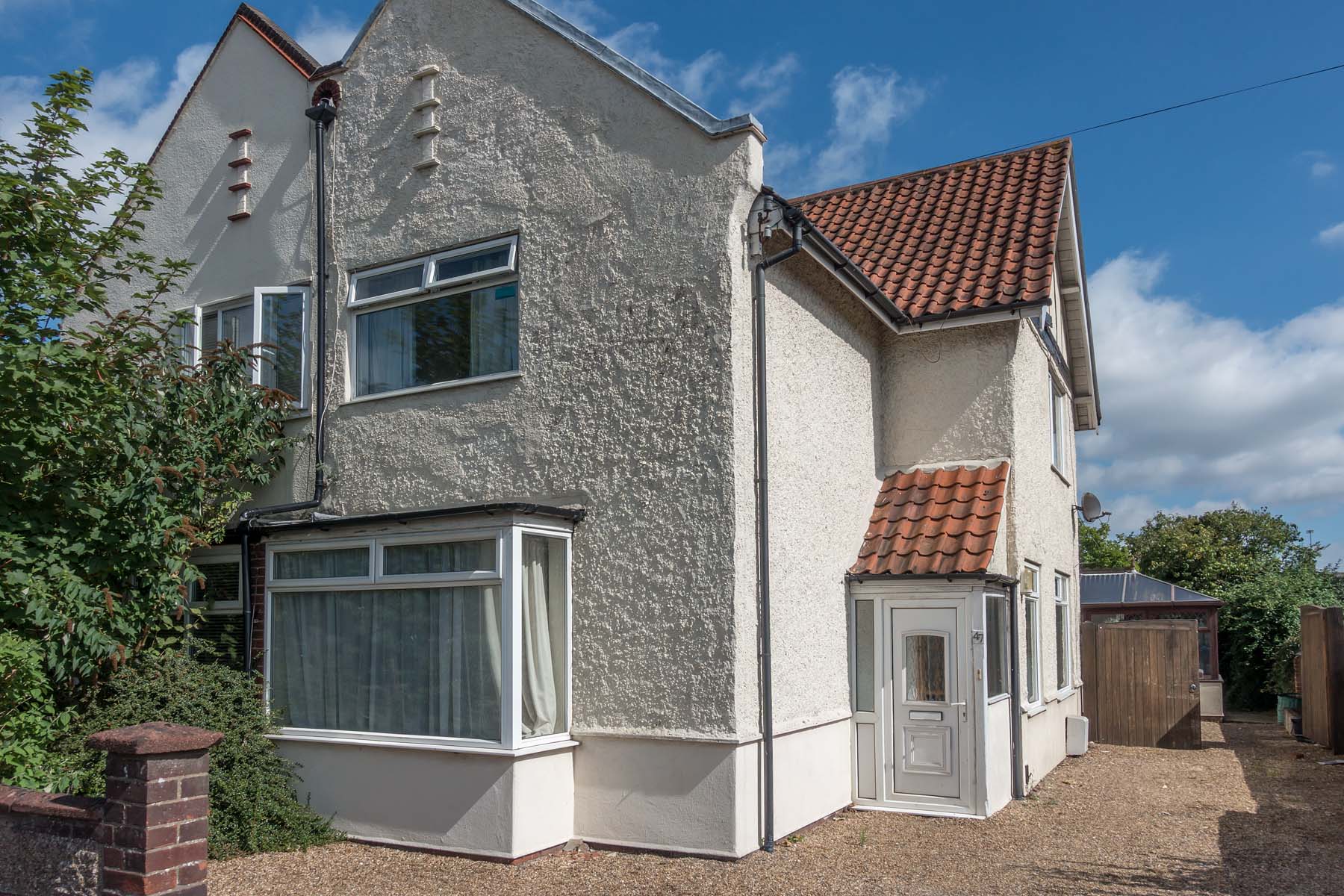 White semi-detached house with large driveway