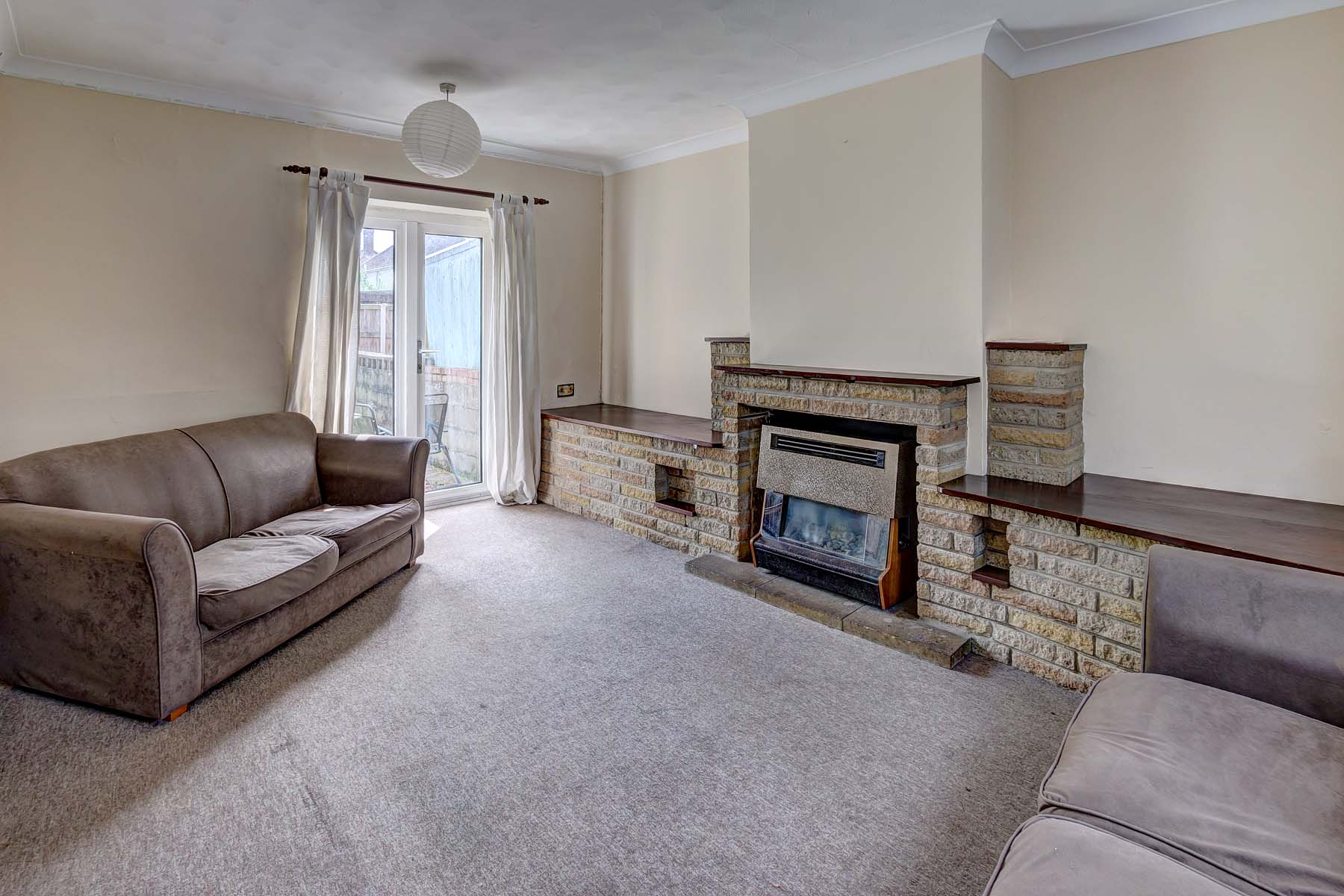 Living room with pale carpet and sofas