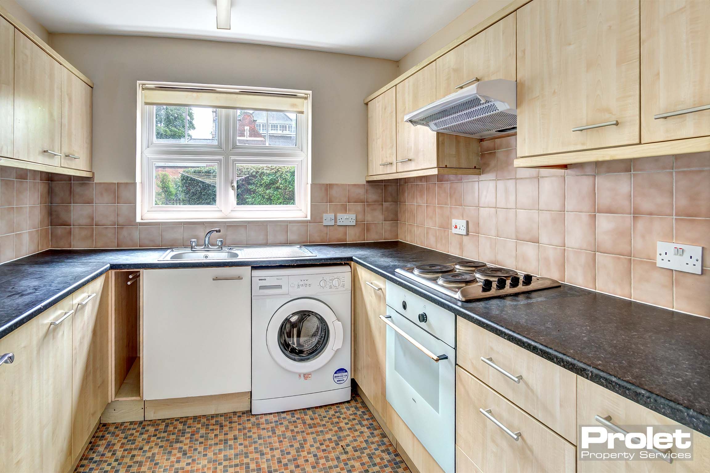 Wooden effect fitted kitchen with washing machine