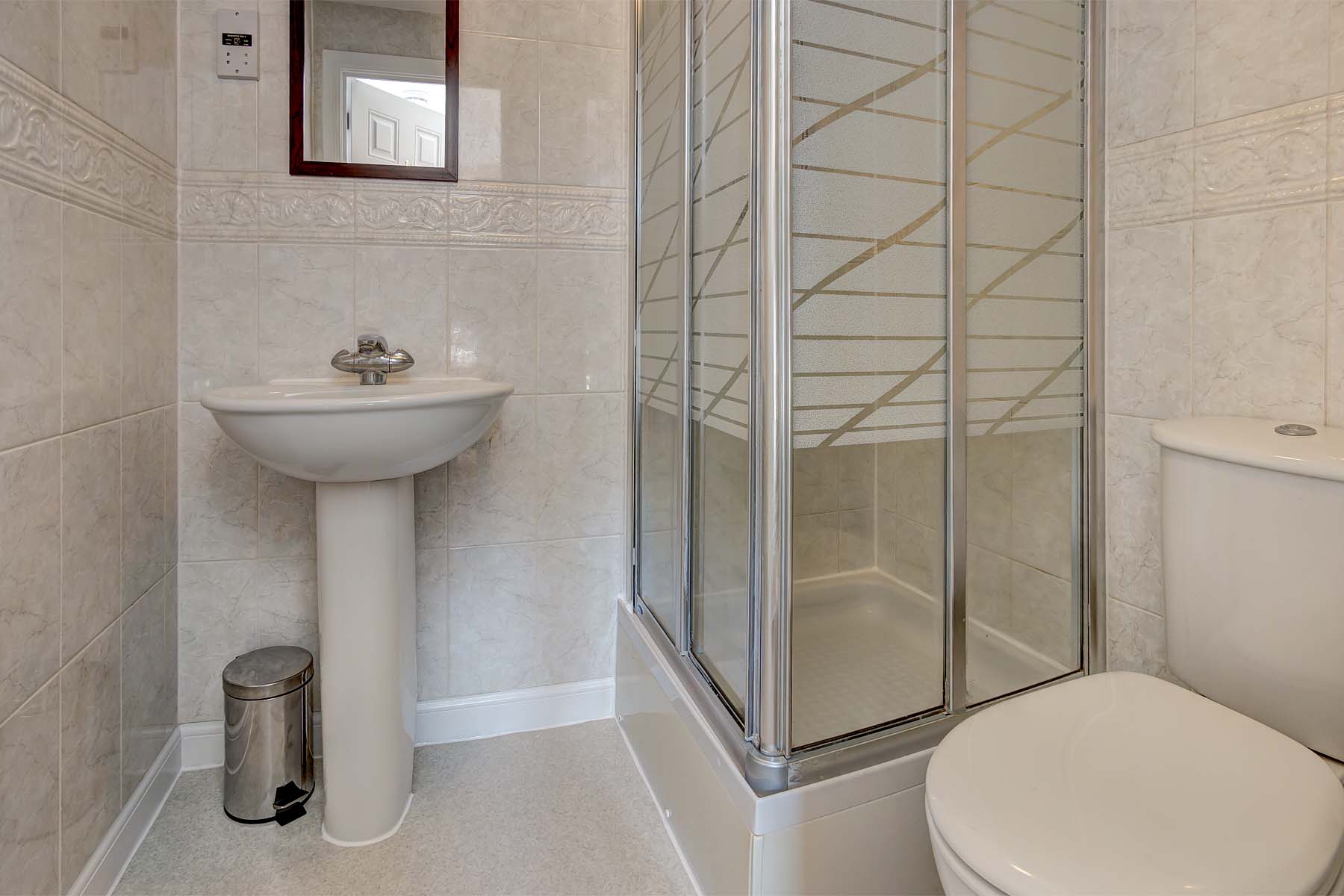 Bathroom with shower cubicle, toilet, and sink