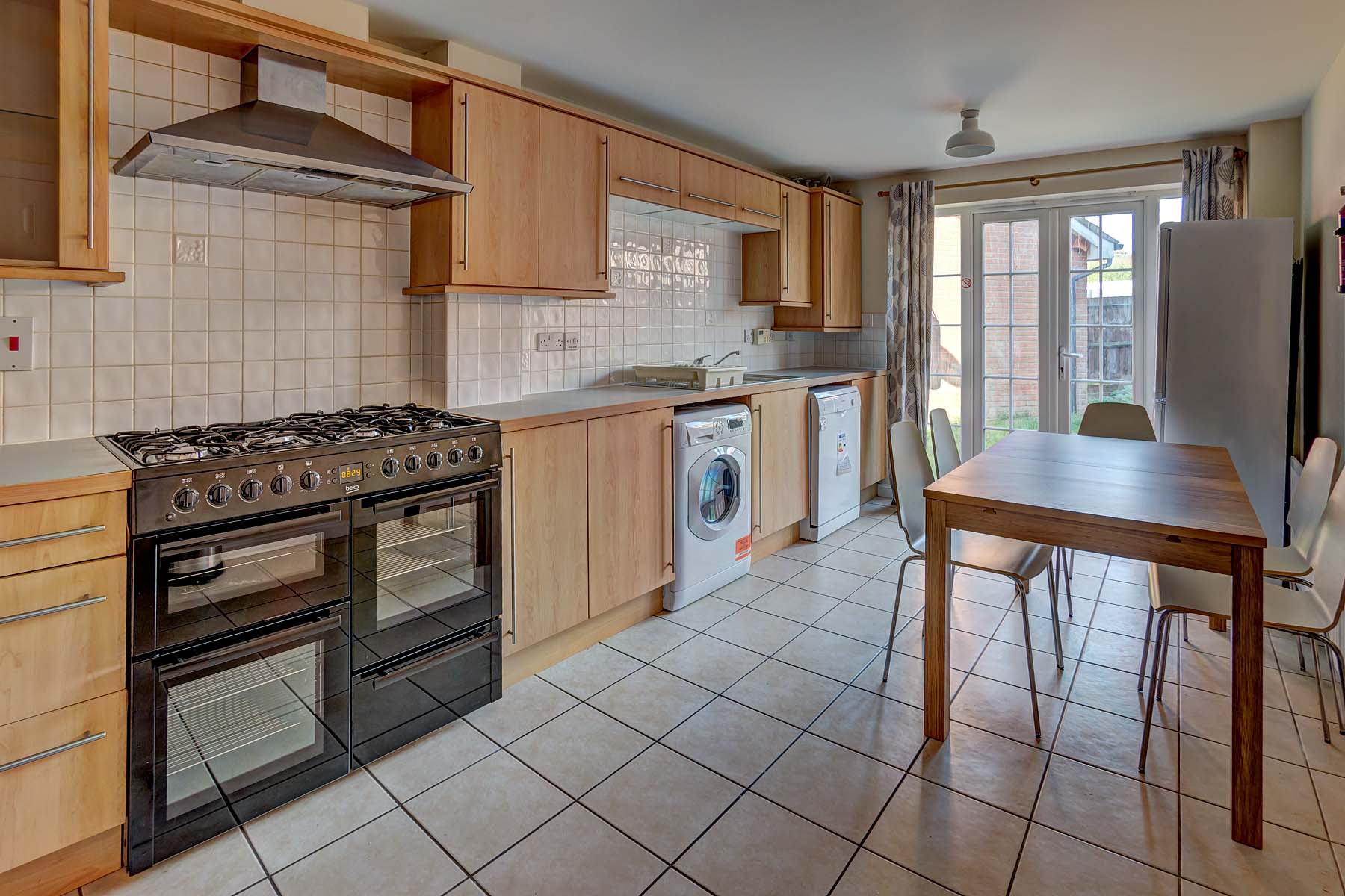 Large kitchen with range style cooker and white goods