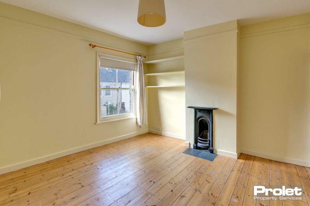 Buttermilk walls with stripped floorboards and feature fireplace