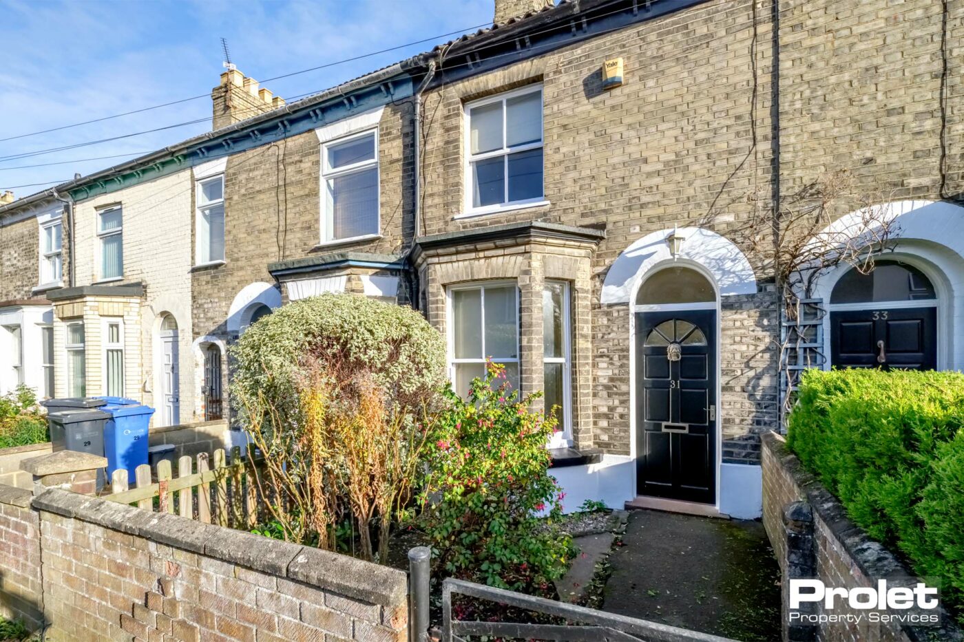 Brick terrace house with brick wall to front