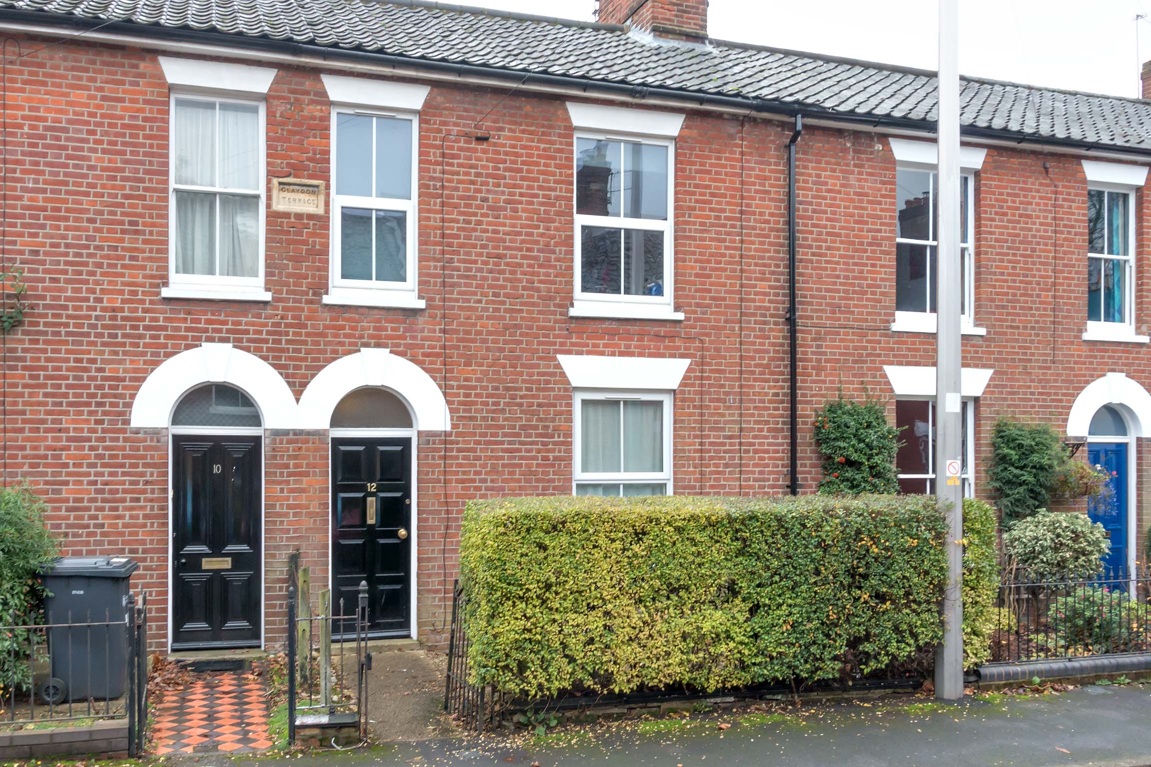 Red brick terraced house with black front door