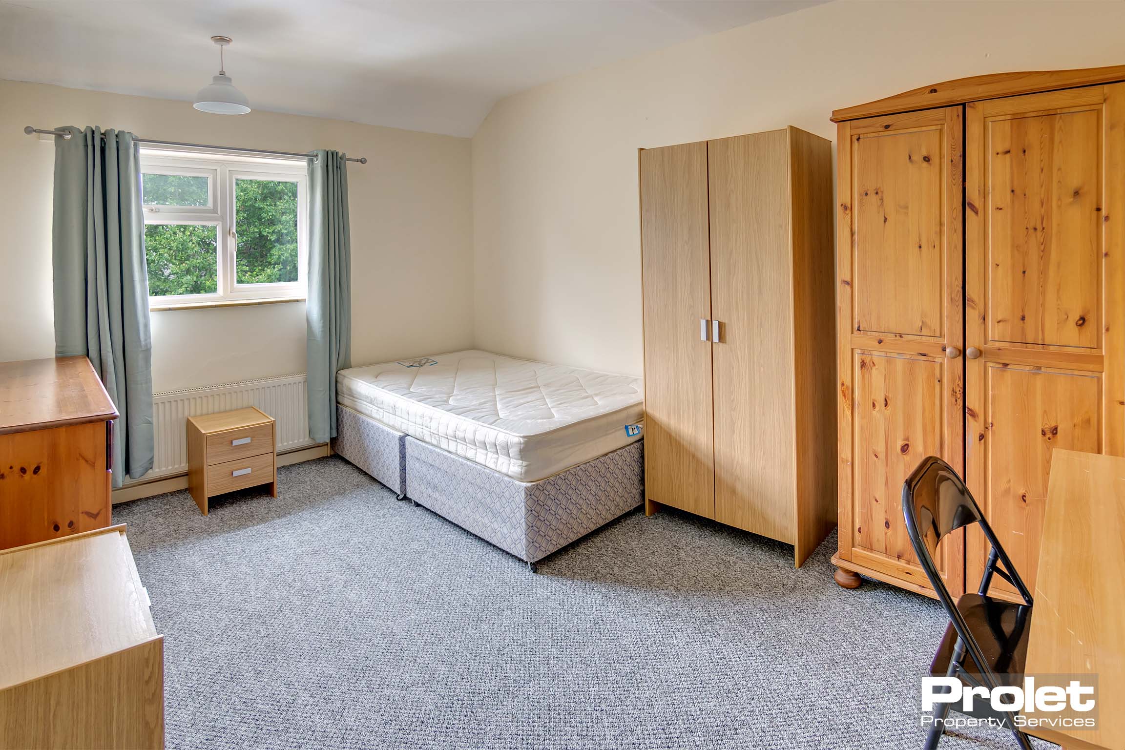 Large double bedroom with bed, and wardrobe