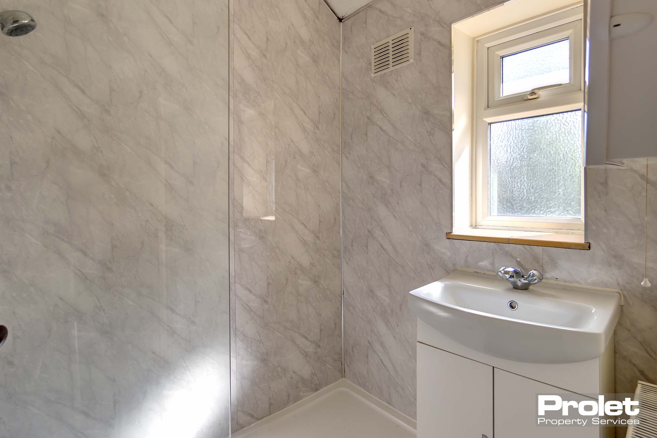 Modern bathroom with tiled shower and sink