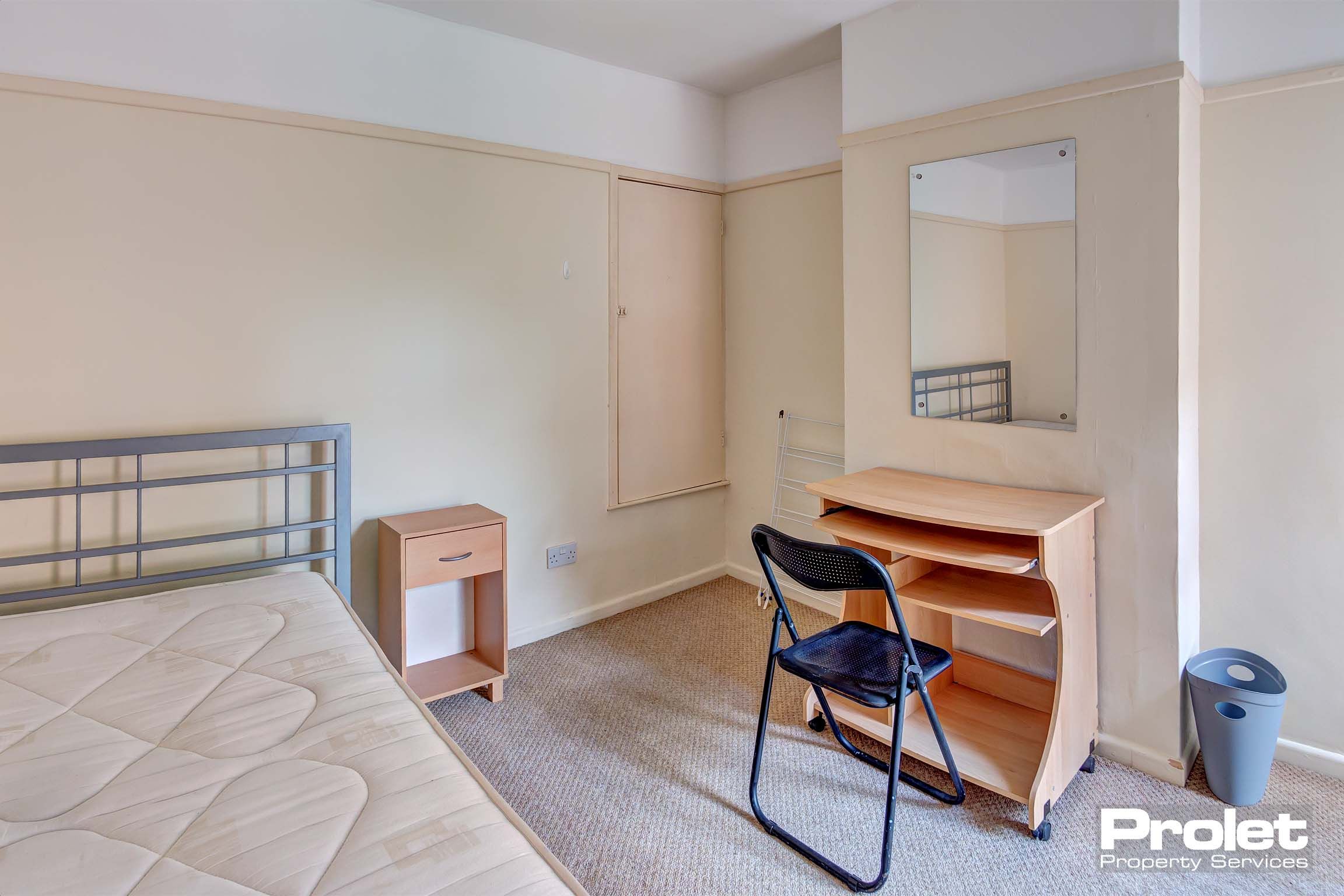 Bedroom with double bed and desk