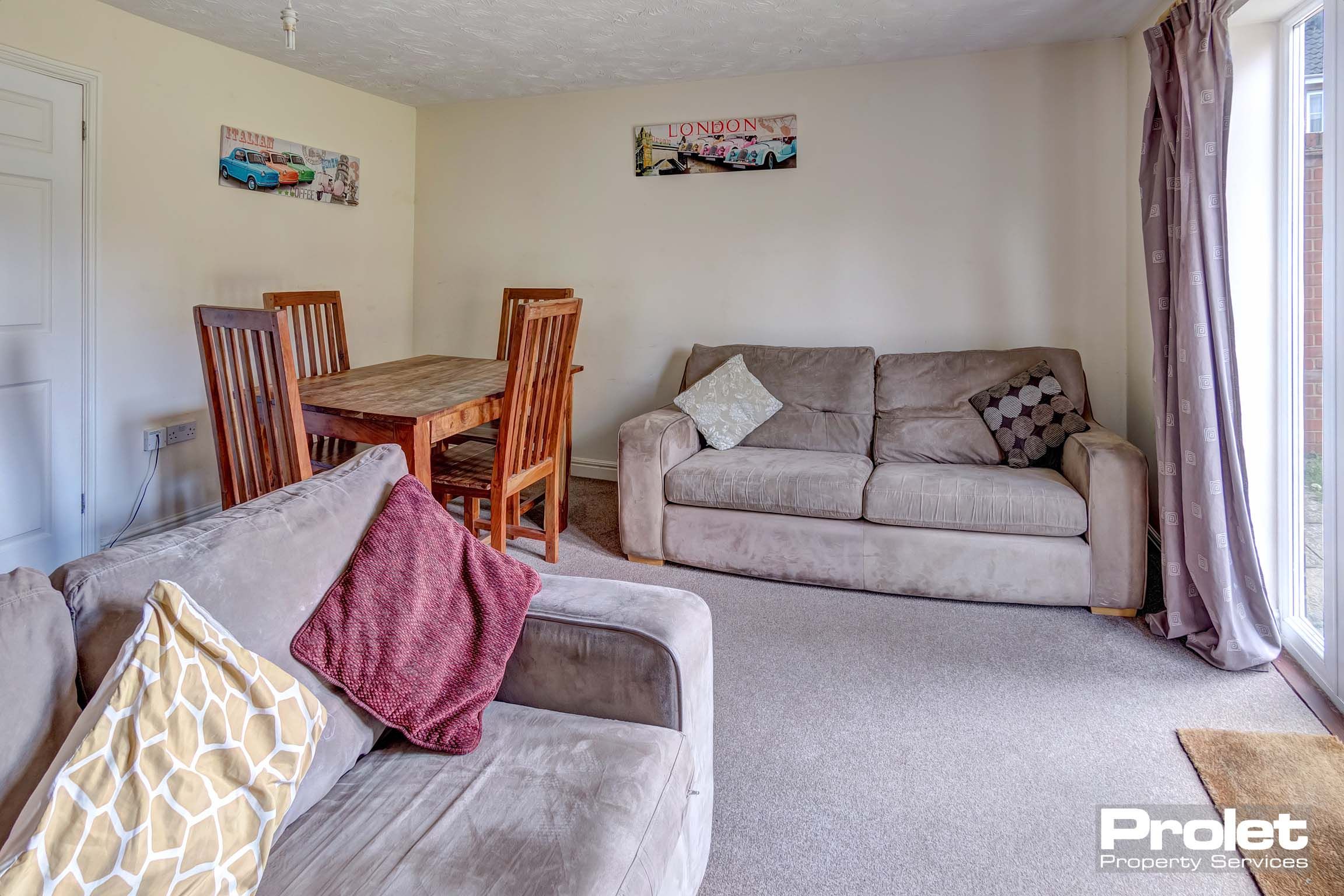 Living room with light carpet, dining table, and sofas