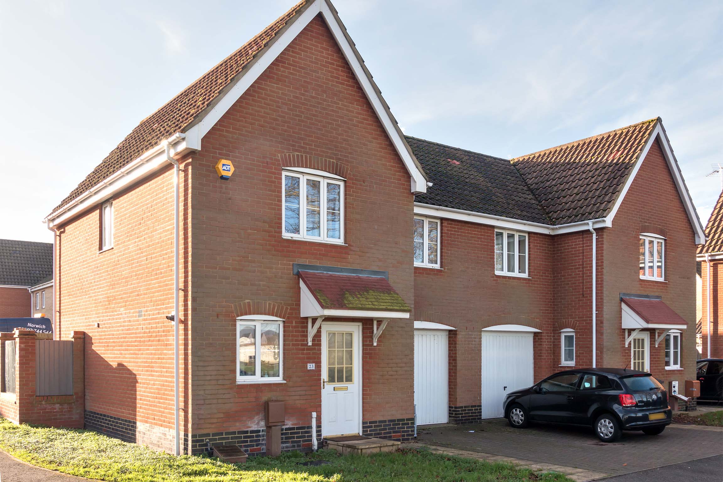 Brick house with white front door and windows