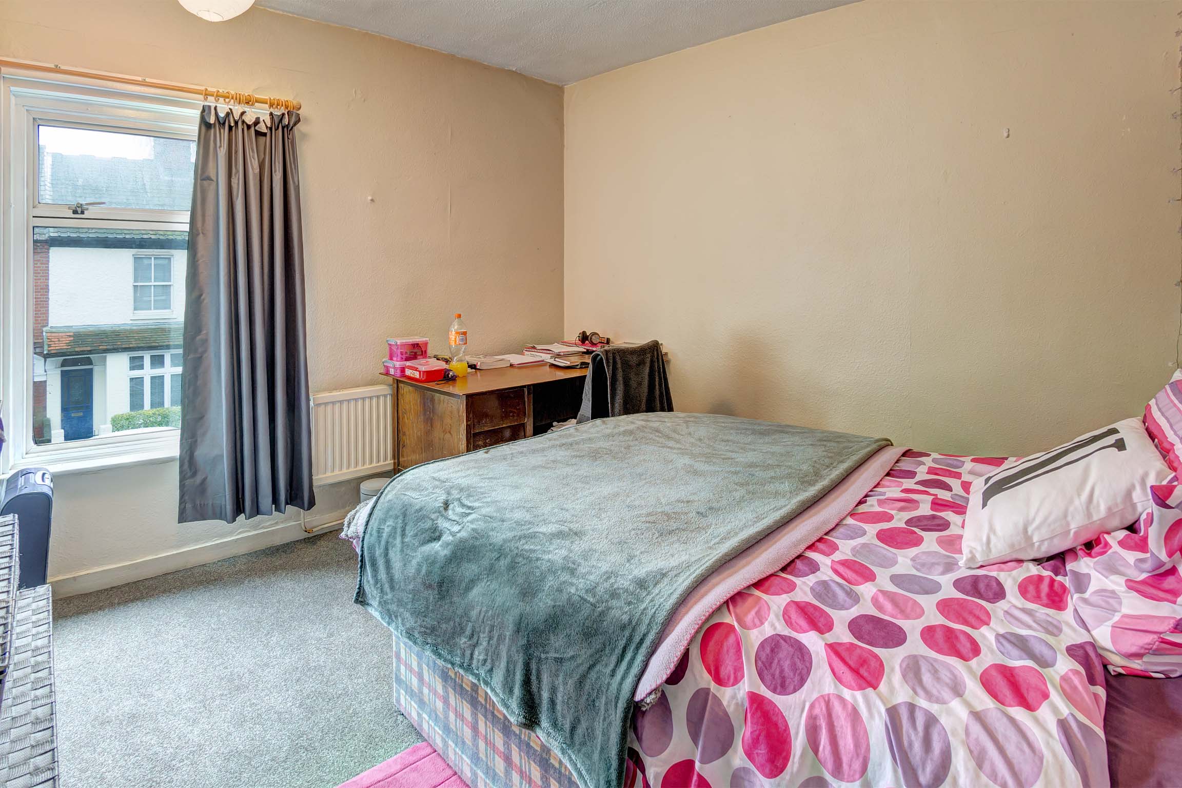 Bedroom with grey carpet and grey curtains