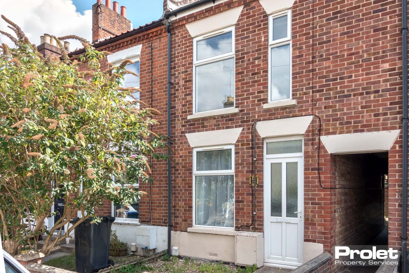 Red brick terraced house with side access