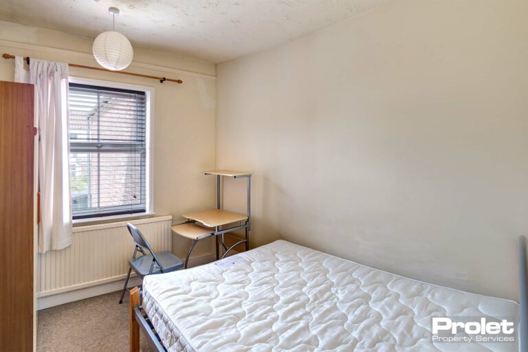 Bedroom with double bed and desk