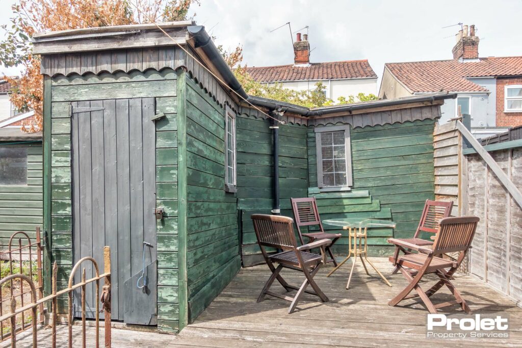 Rear garden with large shed and decking area