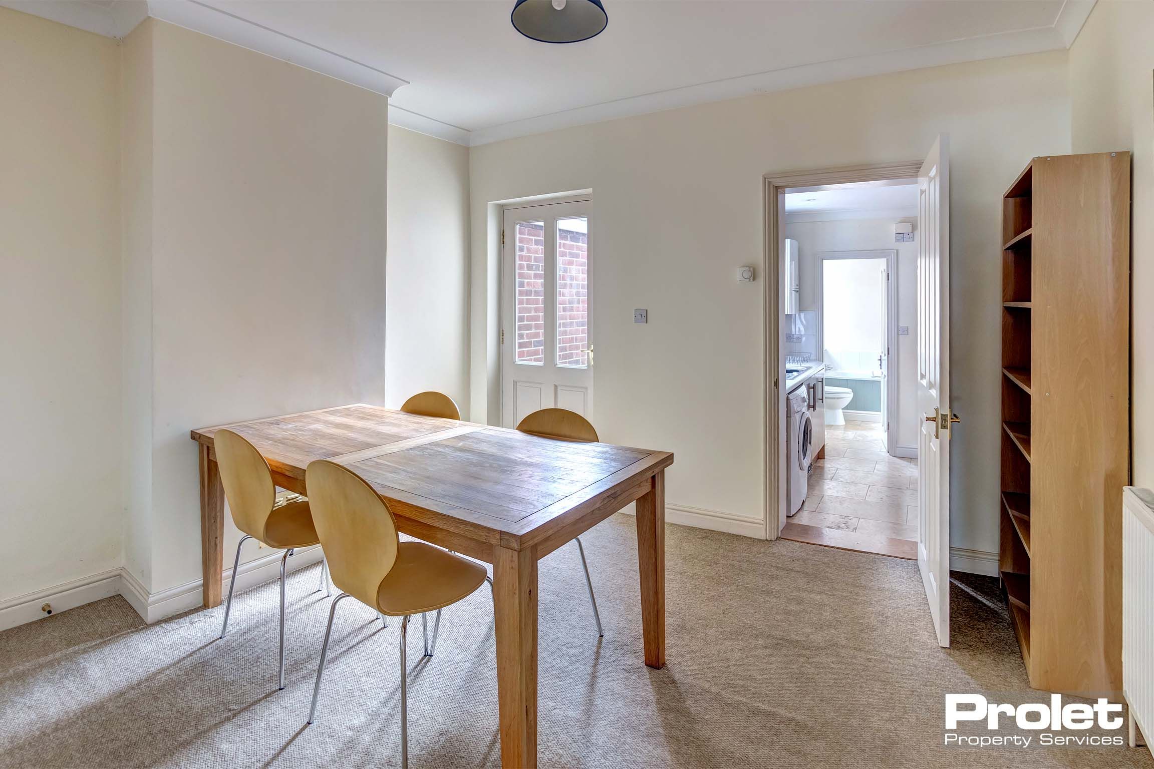 Dining room with dining table set leading to kitchen