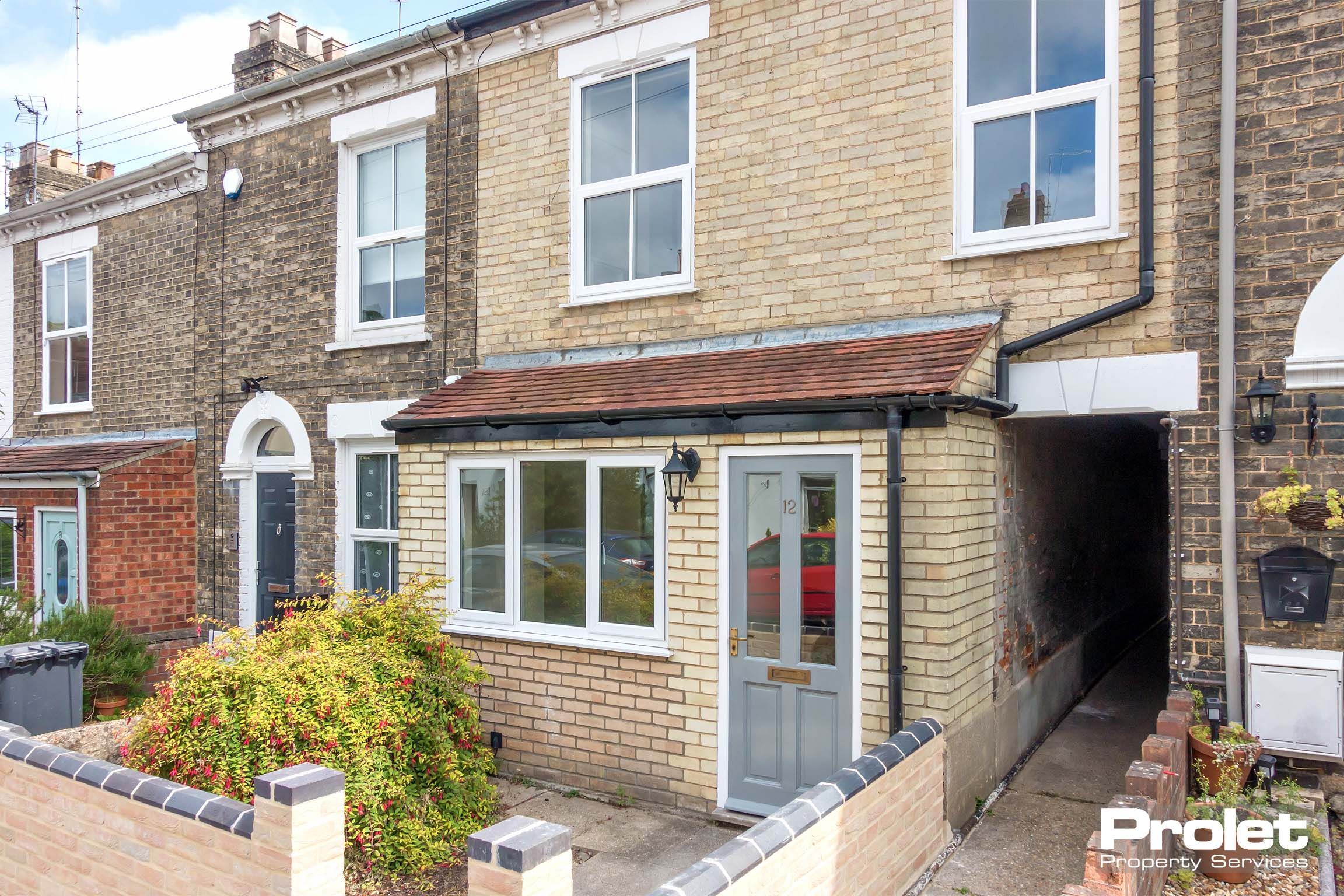 Brick terraced property with porch