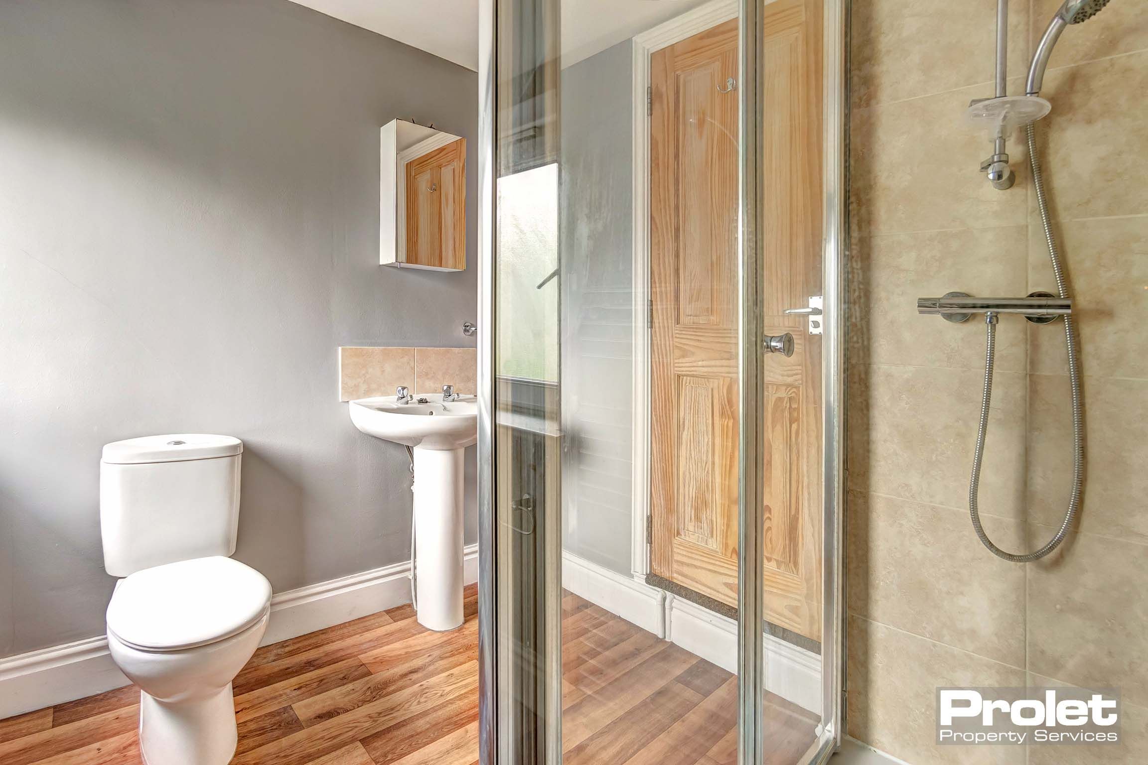 Bathroom with shower cubicle, toilet, and sink