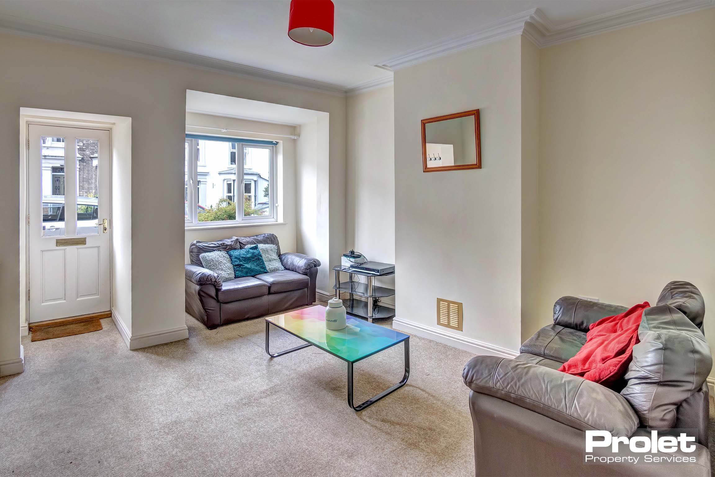 Living room with bay window and sofas.