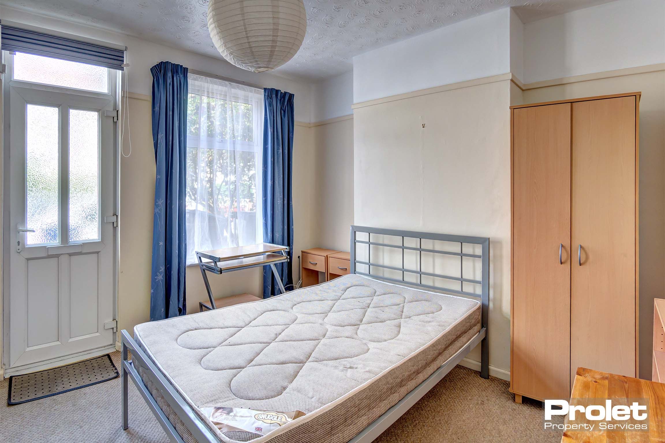 Bedroom with double bed and wooden furnishings