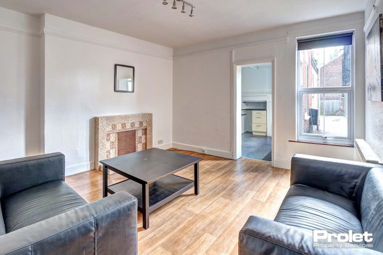 Living room with leather effect sofas and coffee table