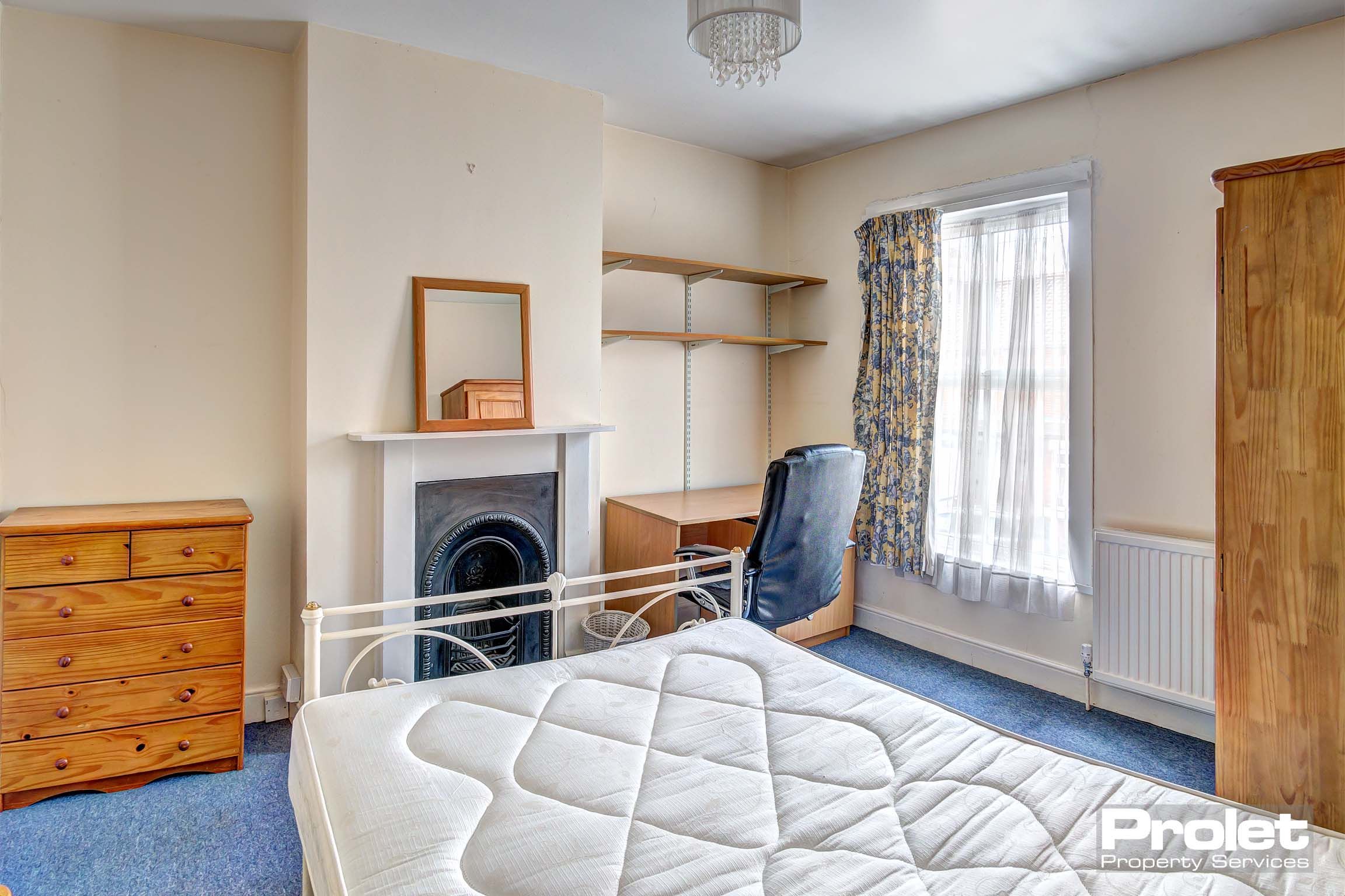 Double bedroom with period fire place and shelves